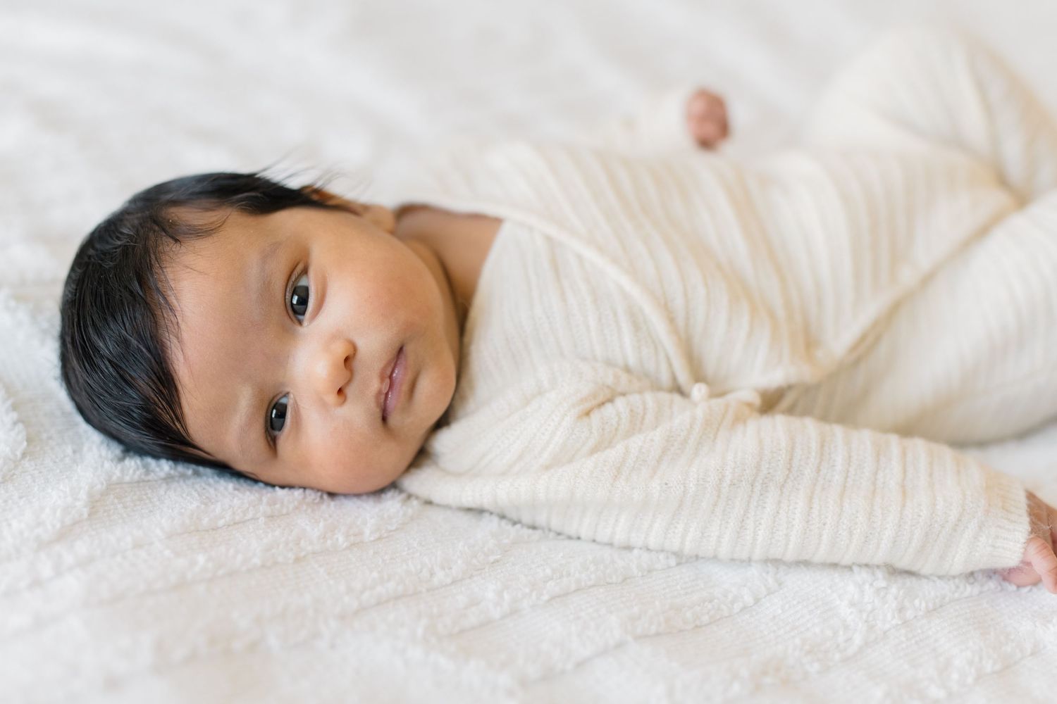 Baby laying with her eyes open during a newborn shoot in Kuna Idaho