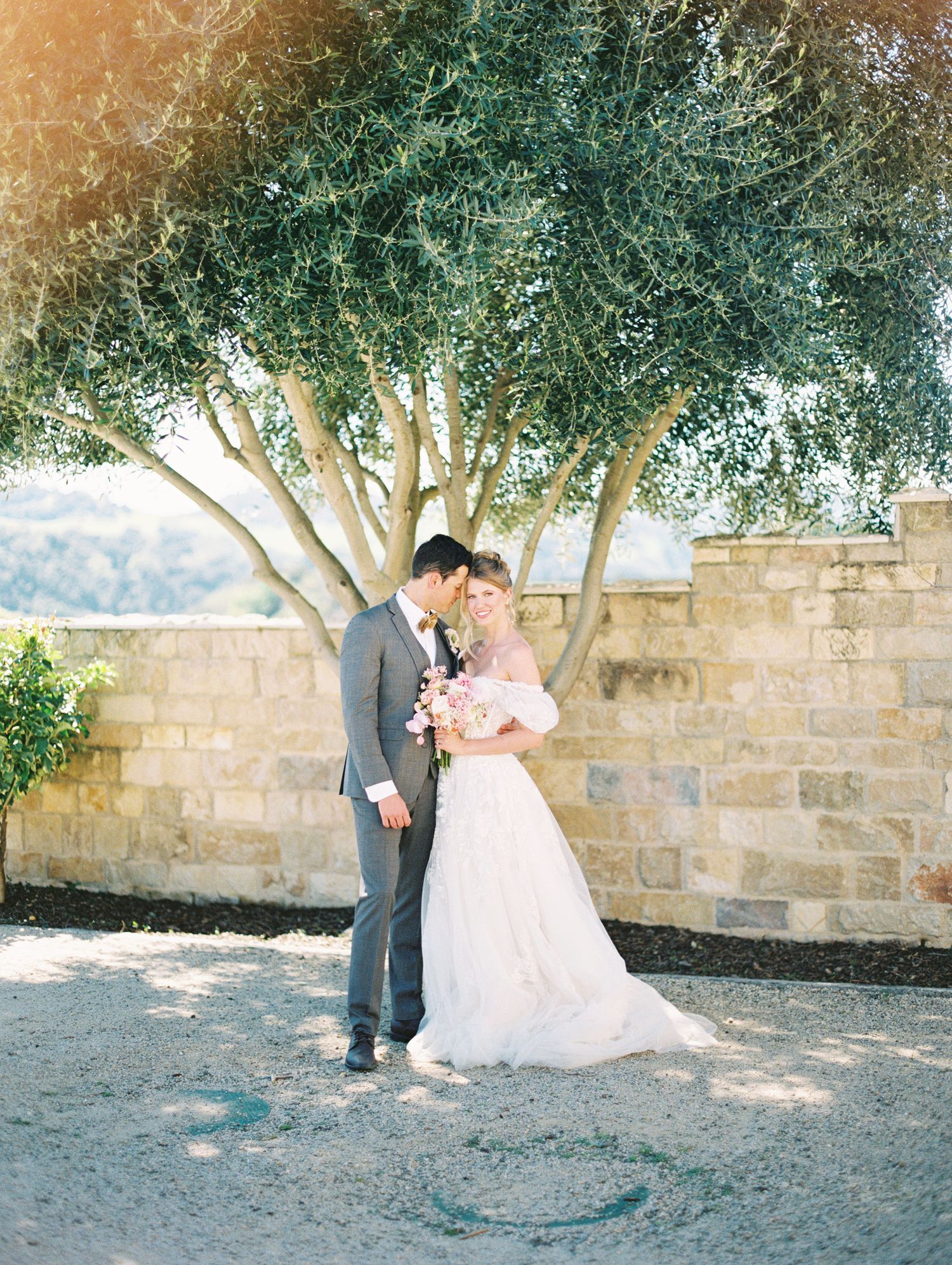 Bride and groom candid moment post-ceremony, warm film tones by Natalya Mark Photo.