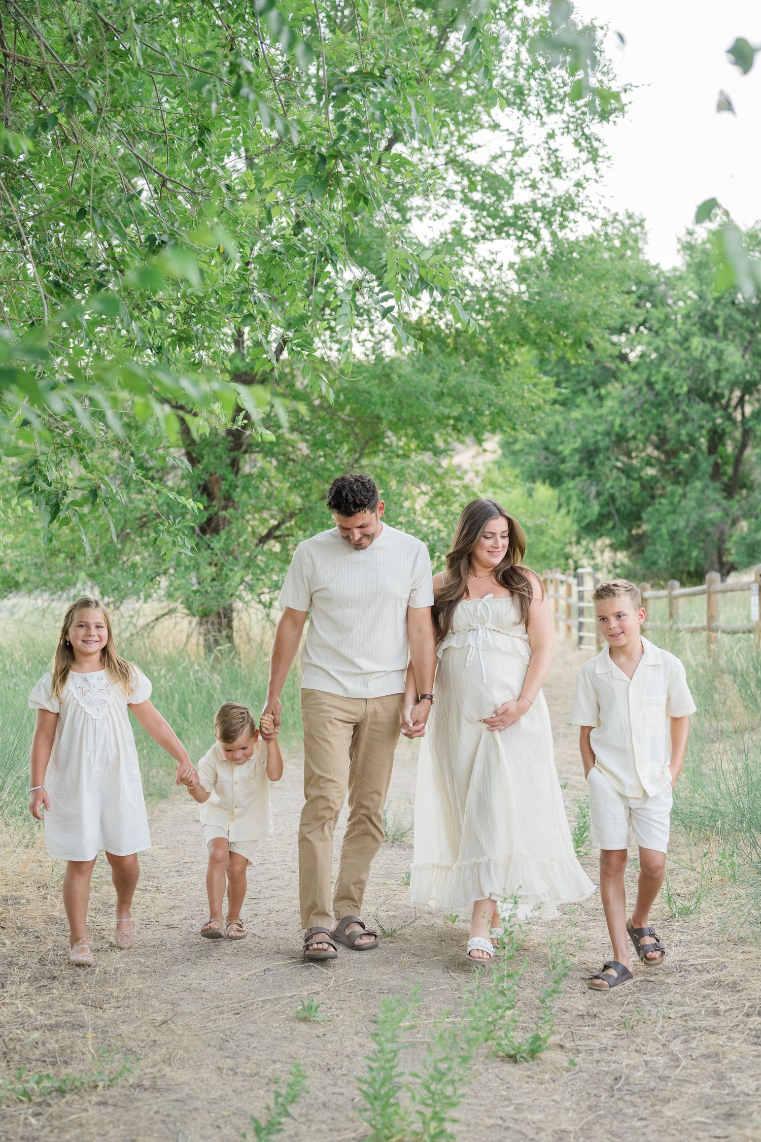 Outdoor lifestyle family photo in Boise with warm lighting and neutral outfits.