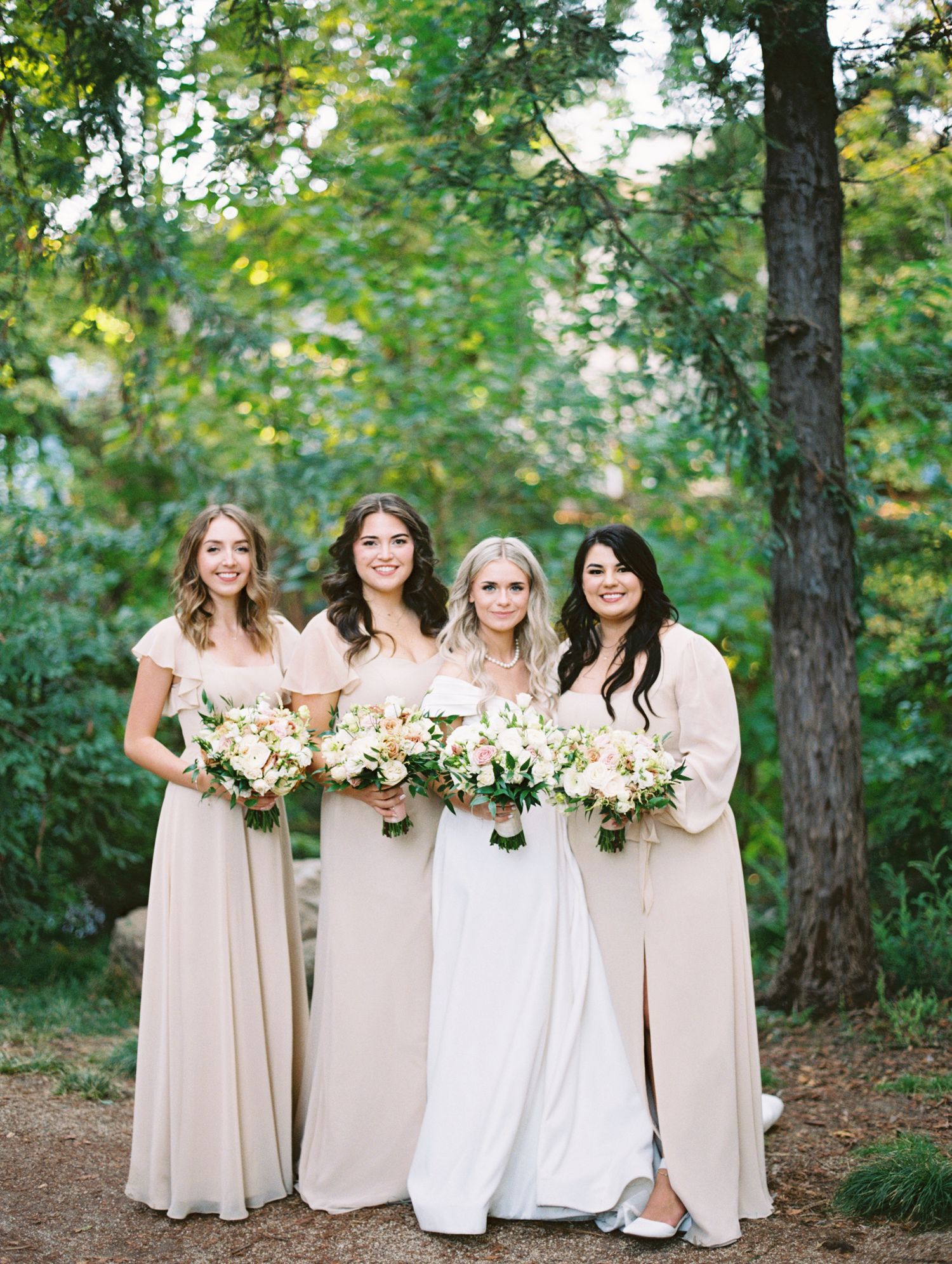 Bride and her girls smiling at each other