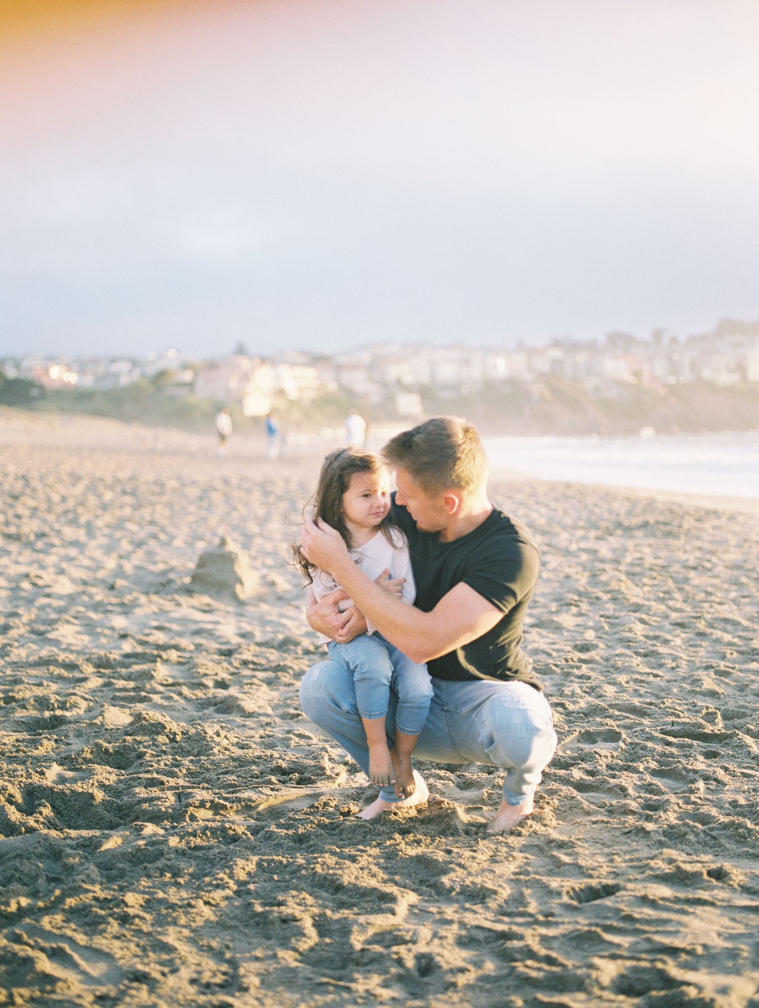 family laughing together during golden hour engagement session, 35mm film by Natalya Mark.