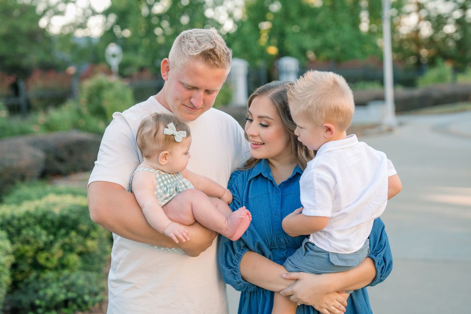 Family of four laughing during golden hour session in Meridian, Idaho, photographed by Natalya Mark Photo.