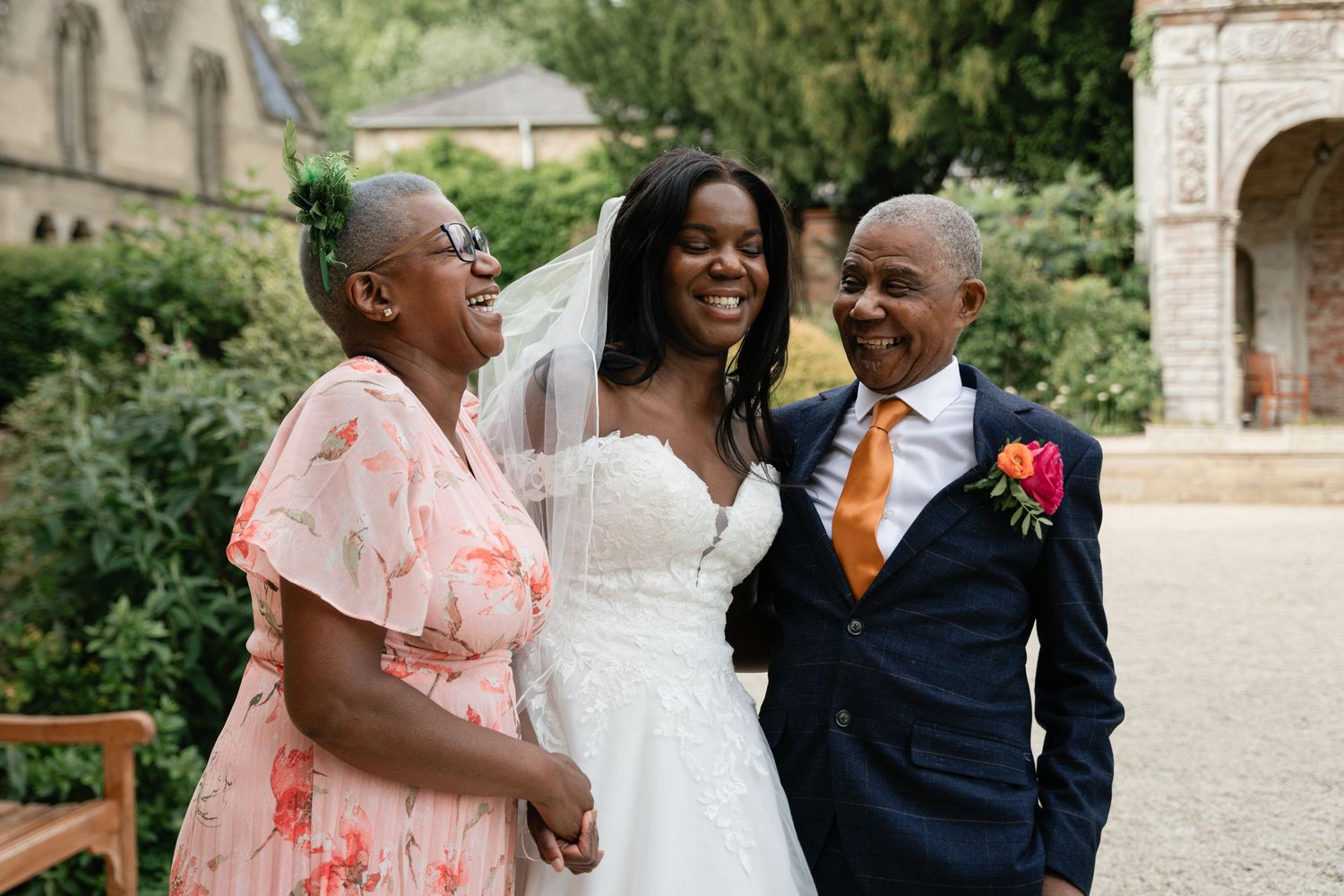 Wedding party members share joyful moments during outdoor celebration in formal attire.
