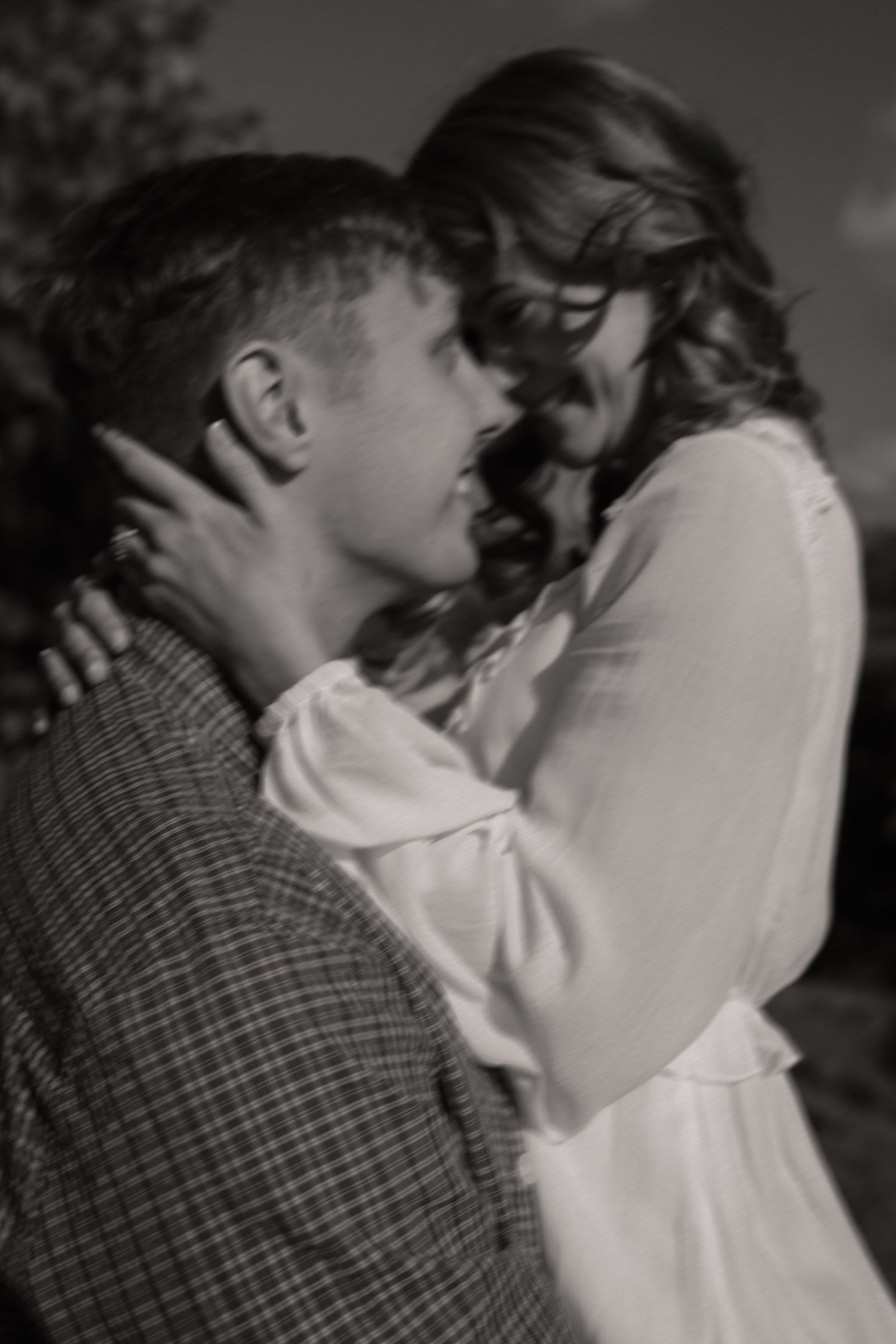 A romantic black and white sequence showing a couple in an intimate embrace.