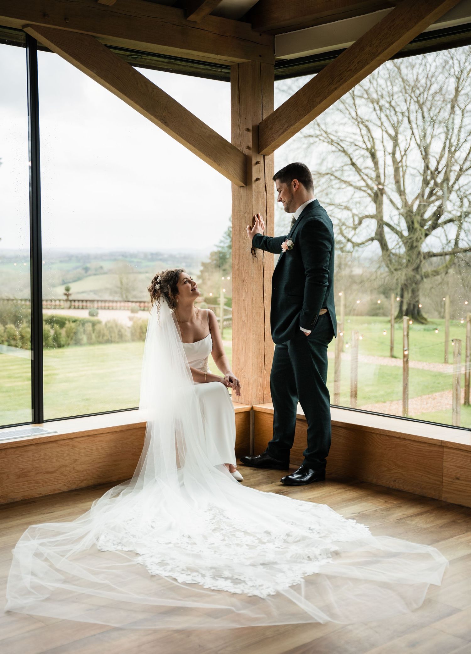 Dramatic wedding photos in rustic wooden venue with panoramic views.
