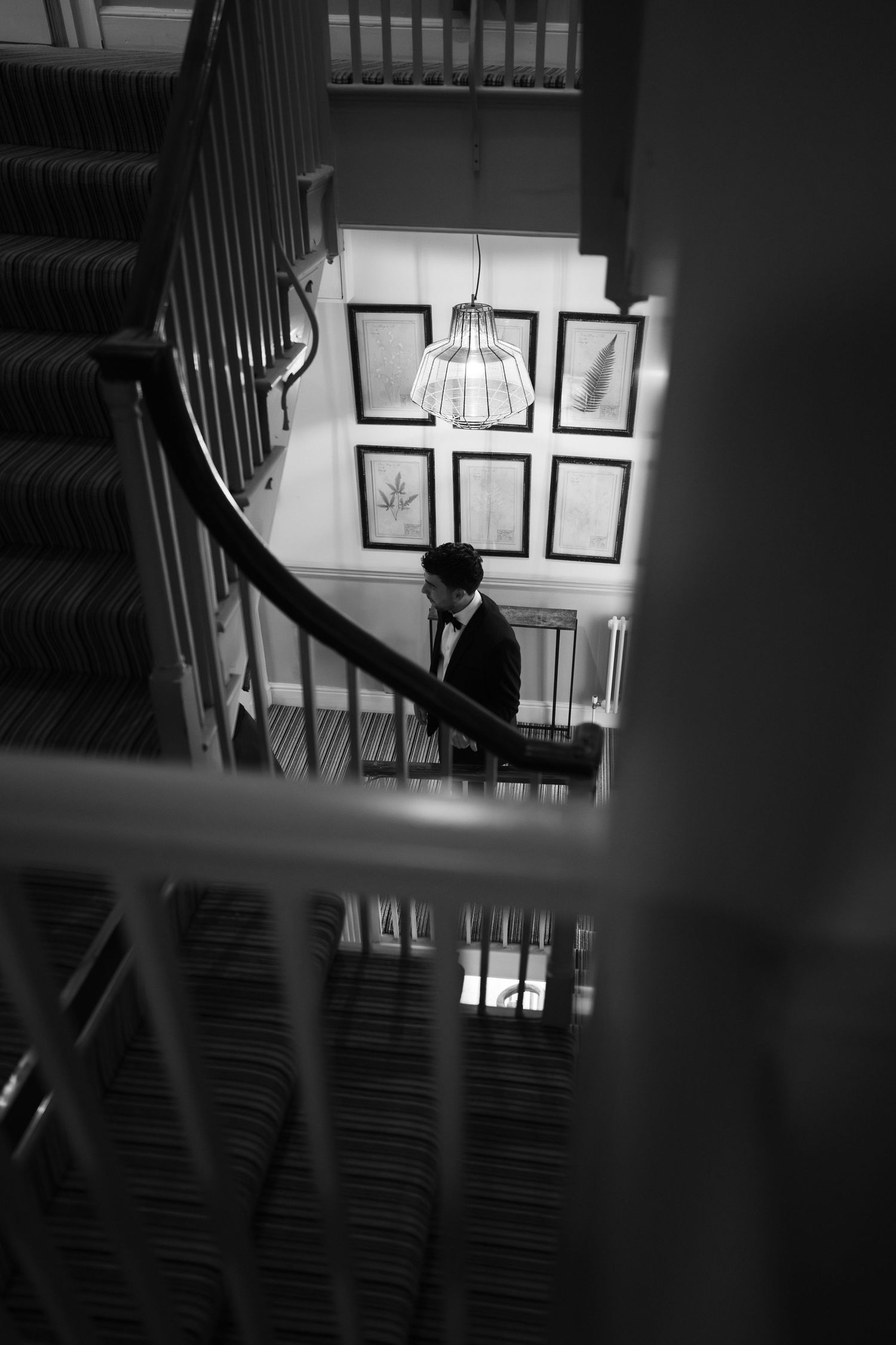 Dramatic black and white staircase shots with natural light streaming through windows.