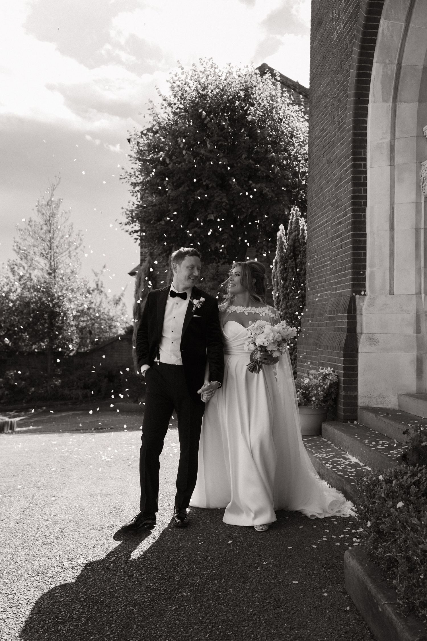 Black and white wedding photos showing a couple in silhouette against a church exterior with trees and natural lighting.