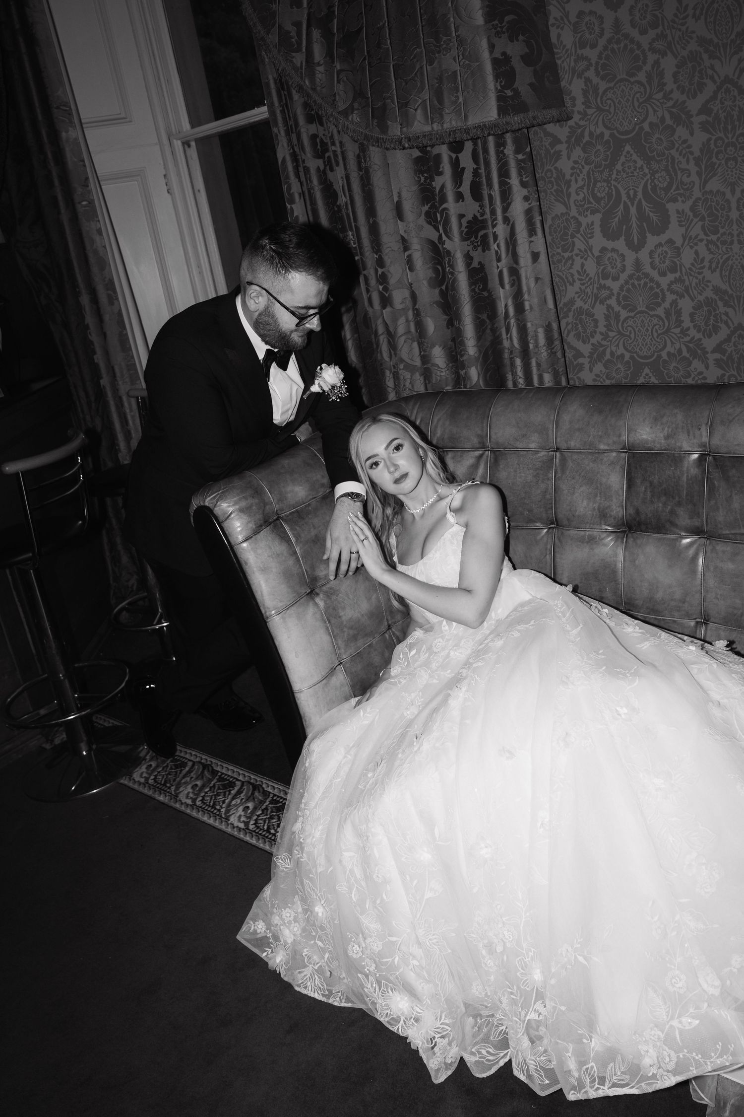 A black and white photo sequence shows a couple dancing together in formal wedding attire at an elegant venue.