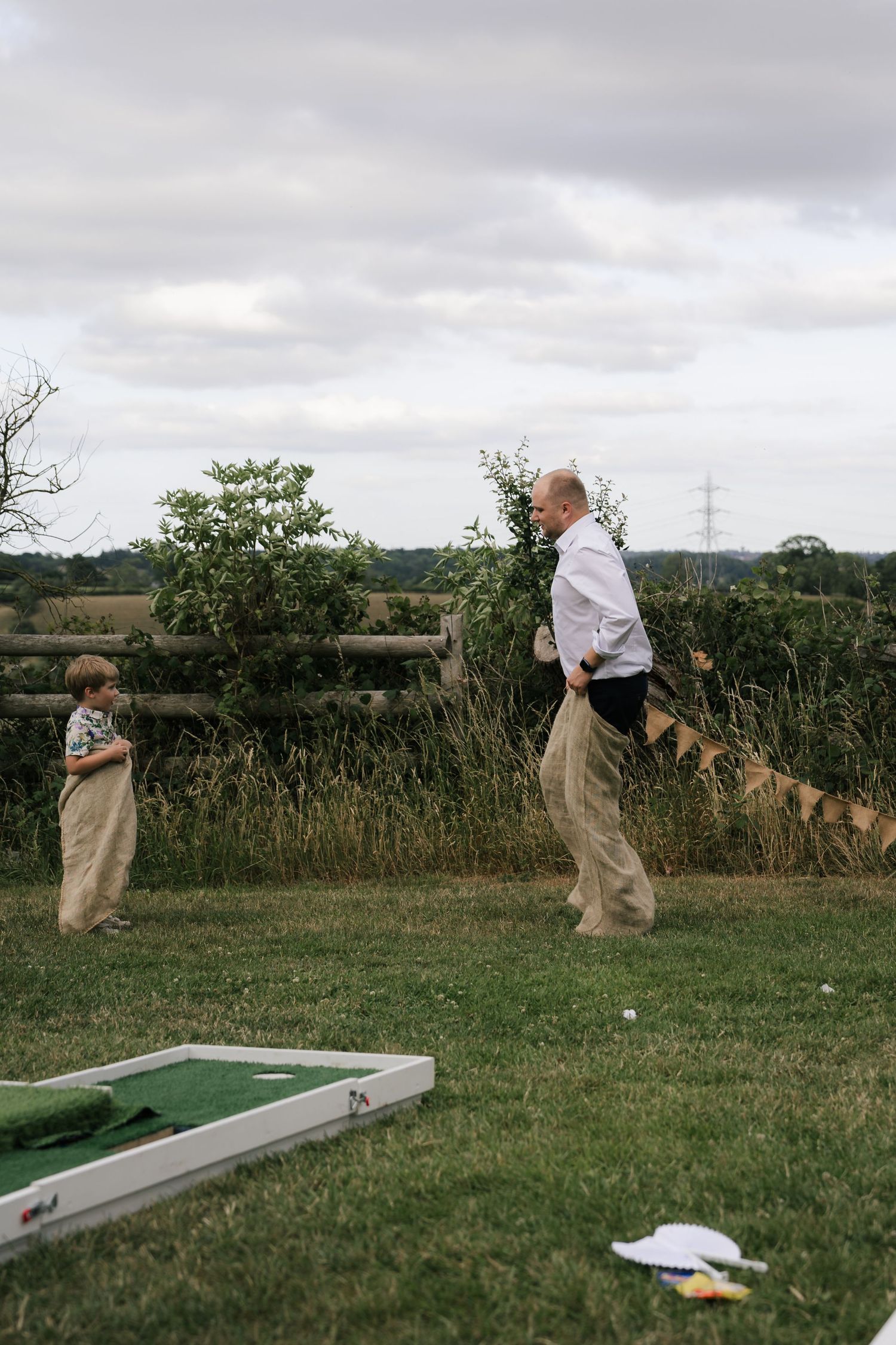 A series of photos showing someone playing mini golf on a portable putting green set up on grassy terrain.
