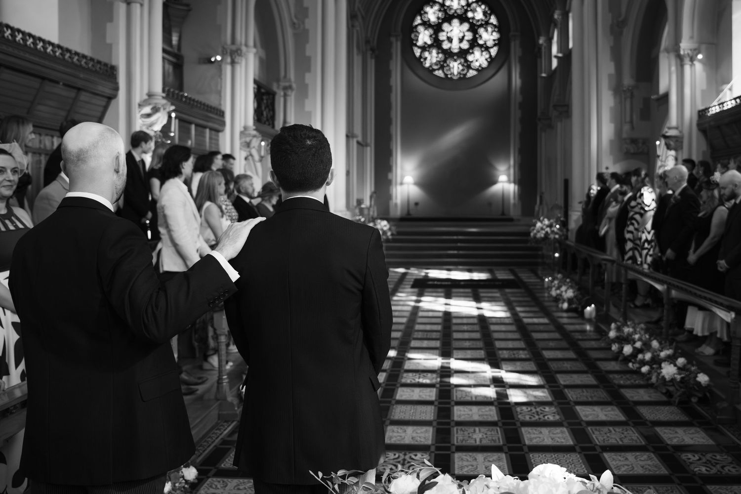 Black and white panoramic photo sequence showing a church wedding ceremony with dramatic lighting and architecture.