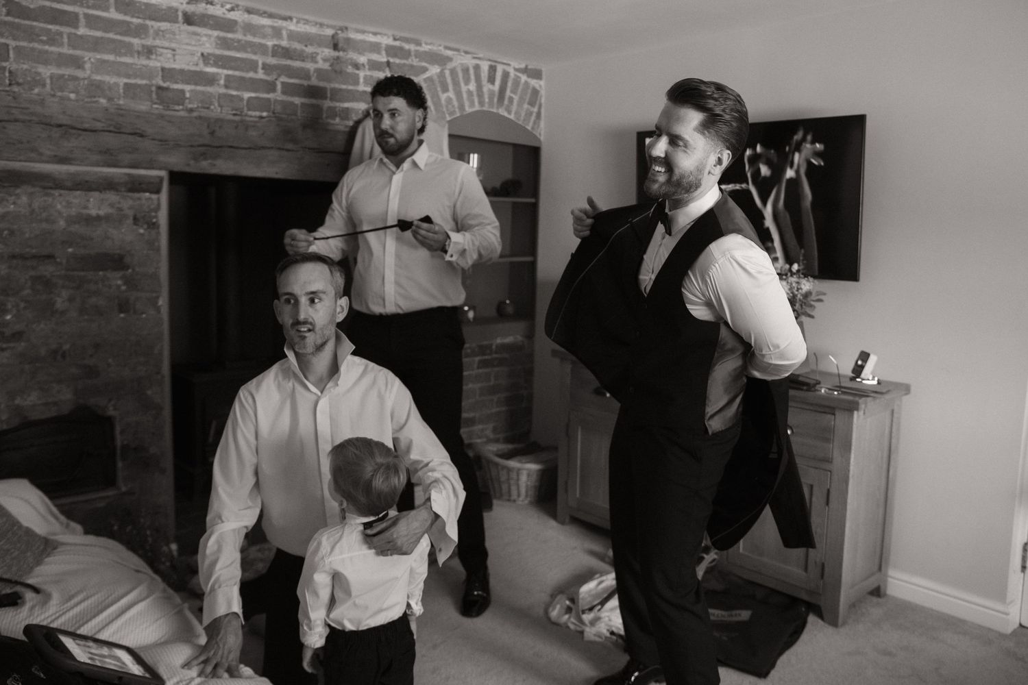 Group of people engaged in animated conversation at a brick-walled gathering space.