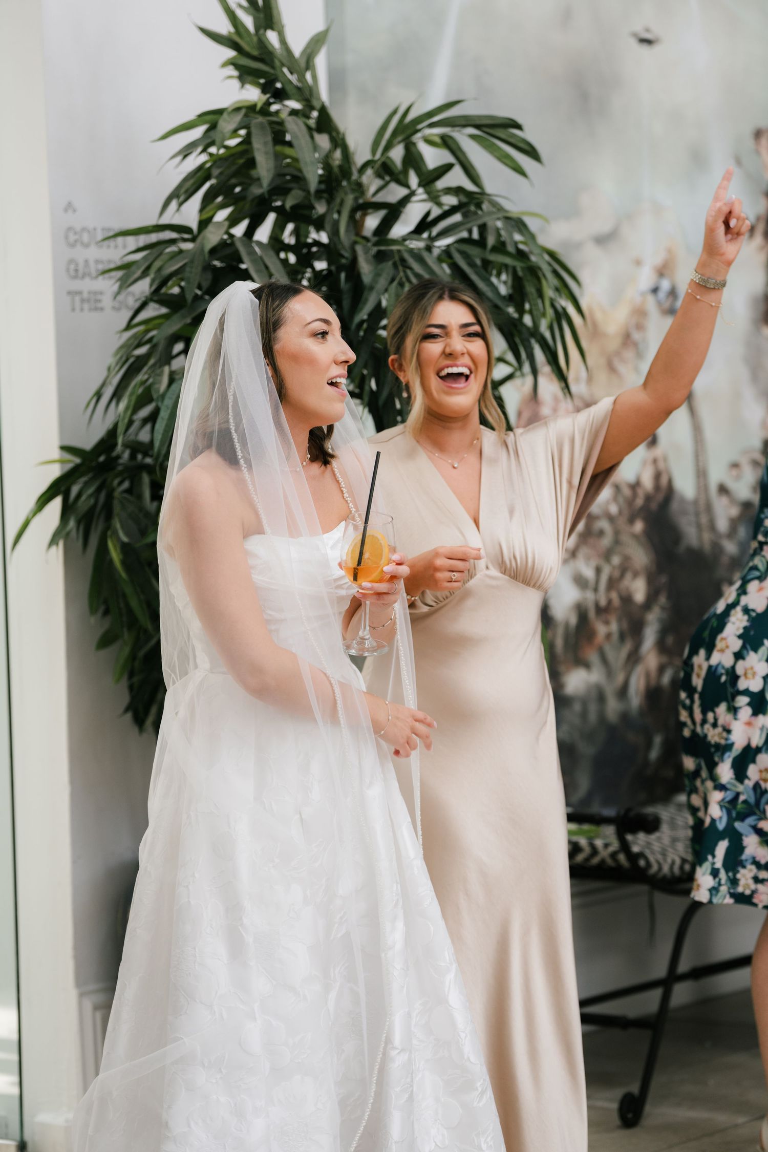 Four candid moments of a bride and bridesmaid sharing laughter and drinks during a wedding celebration.