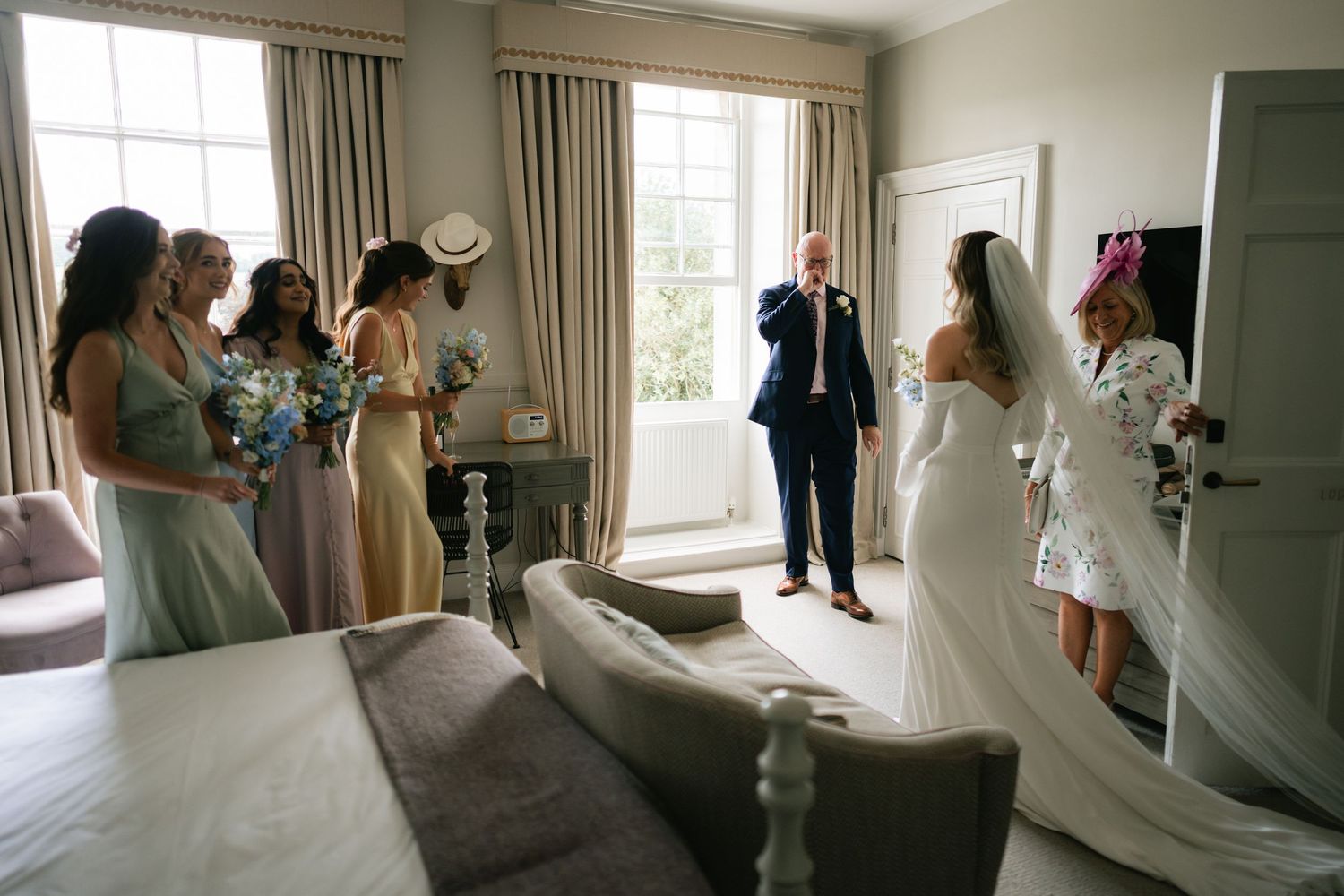 A series of candid moments captured during wedding preparations in a sunlit room with white dresses and elegant decor.