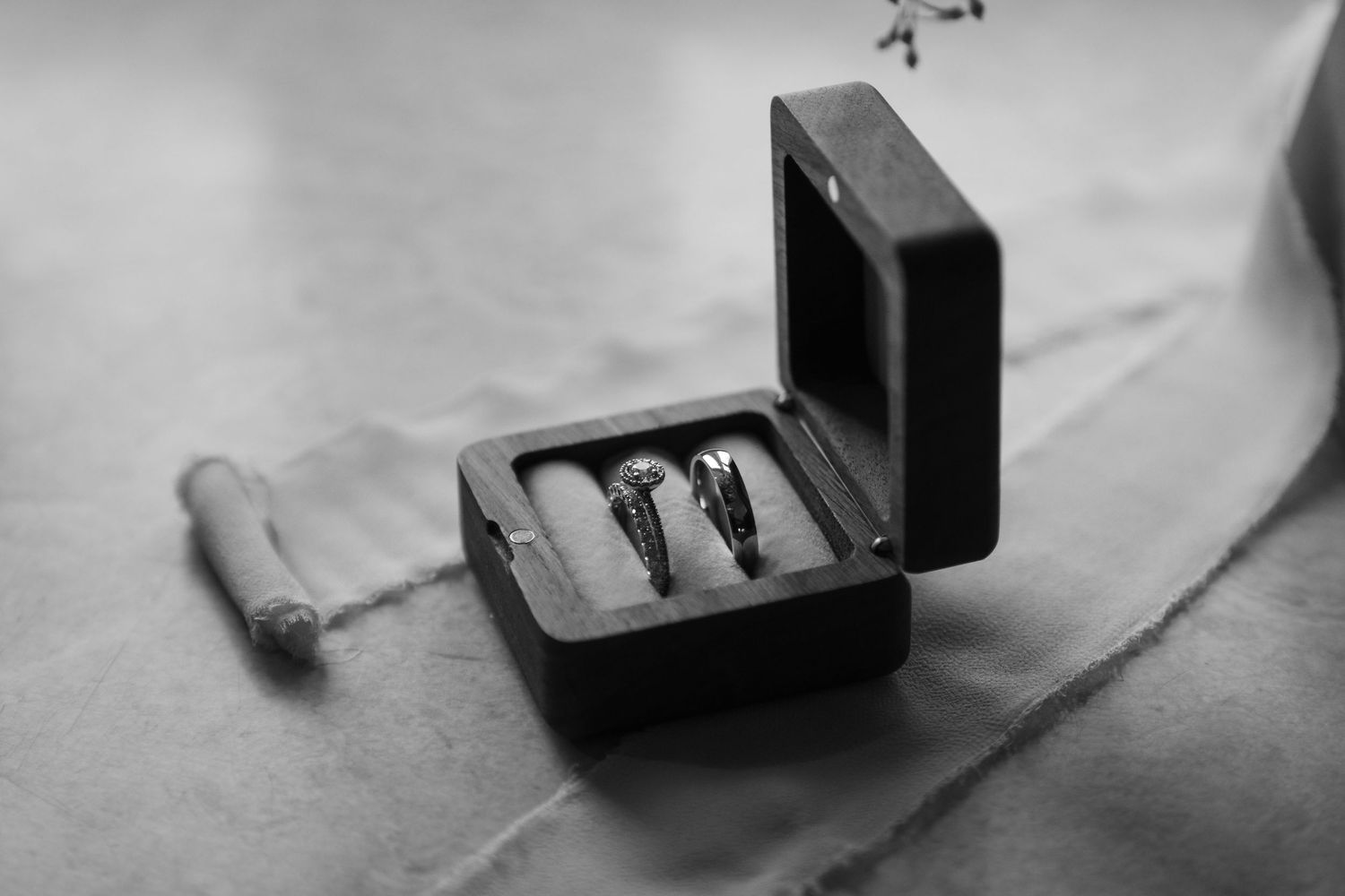Black and white photo of a vintage Polaroid camera being loaded with instant film.
