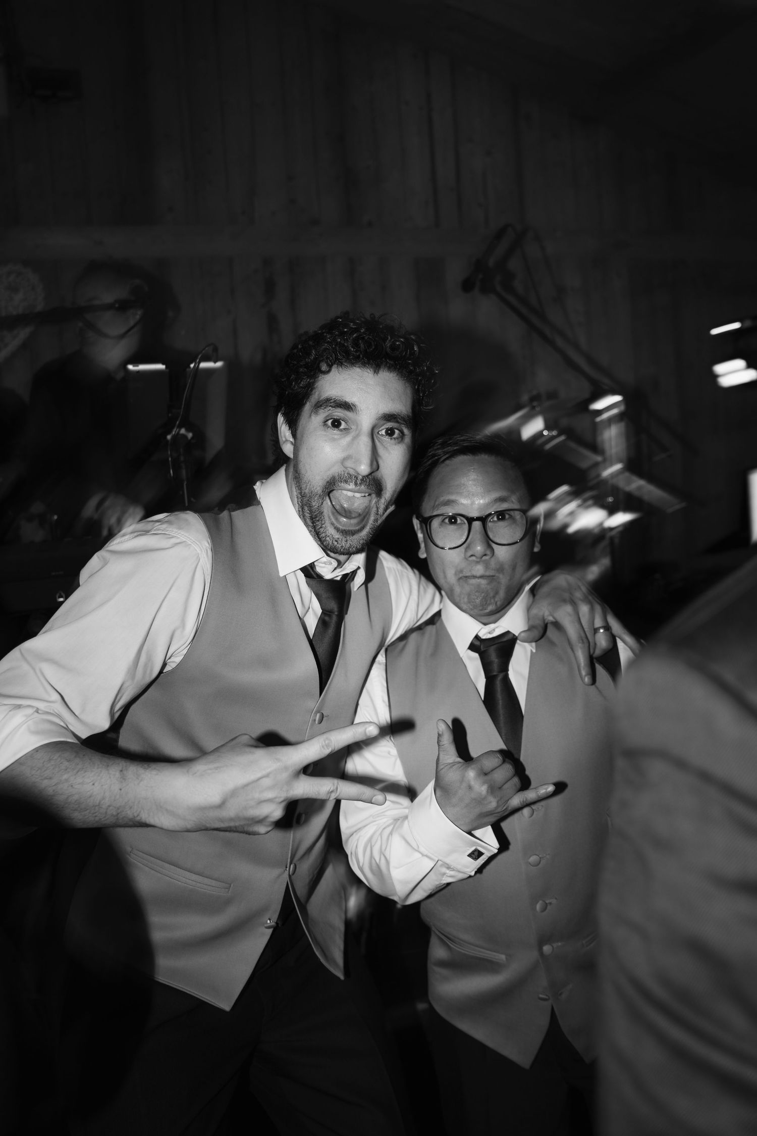A series of black and white photos showing two people in white shirts posing playfully in what appears to be a dark hallway.