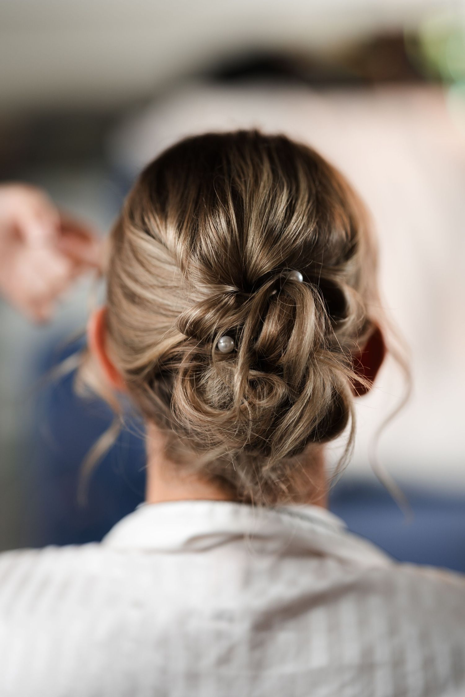 A series of photos showing different angles of an elegant updo hairstyle with twisted and braided sections.