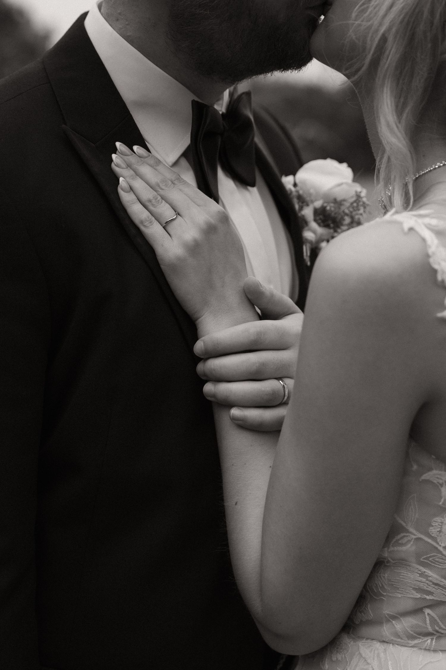A romantic black and white photo series showing intimate close-up moments between a bride and groom.
