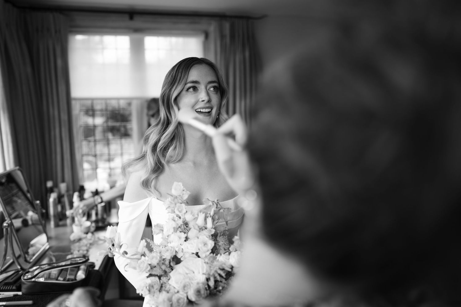 Black and white photo montage showing joyful wedding moments with floral bouquets and candid laughter.