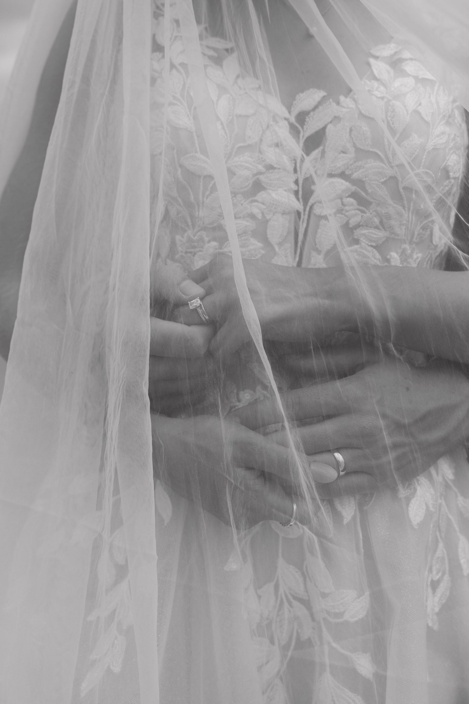 Close-up details of delicate lace and tulle on wedding dress.