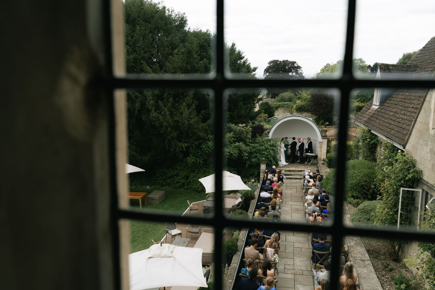 Aerial view of wedding ceremony location and guests arriving from above.