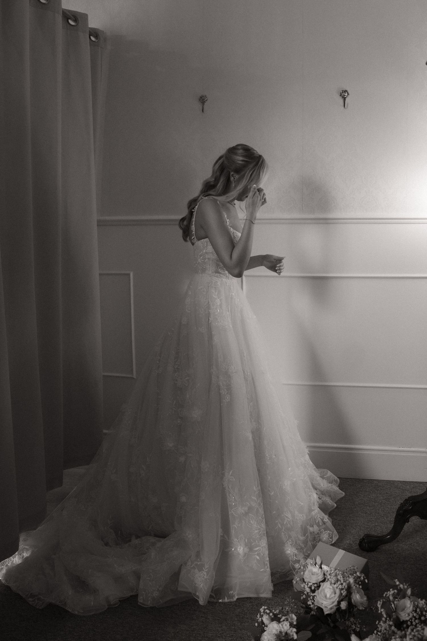A sequence of black and white photos showing a bride in a flowing white wedding gown with a long train.