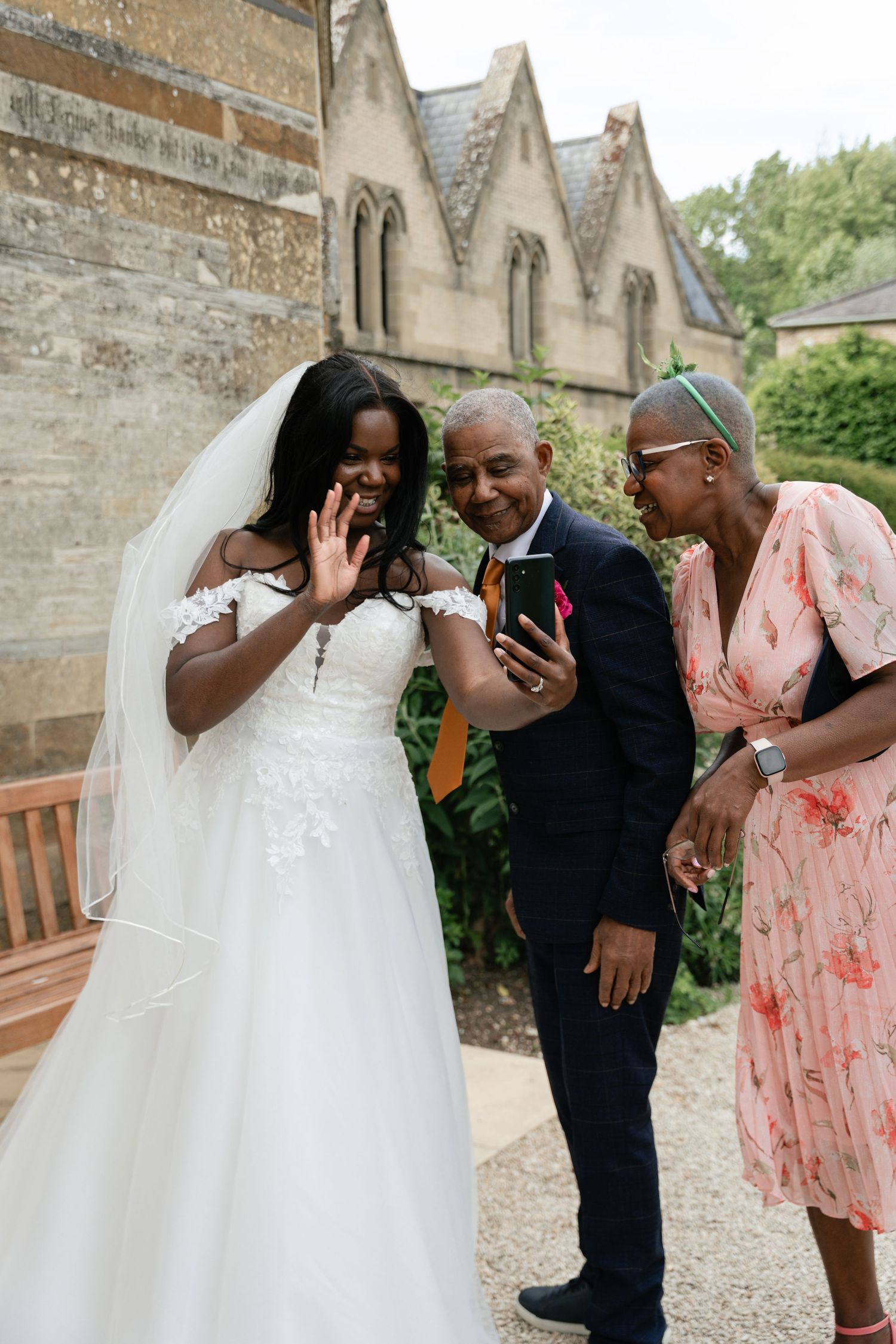 A joyful wedding celebration sequence shows candid moments of laughter and embraces outside a historic stone church.