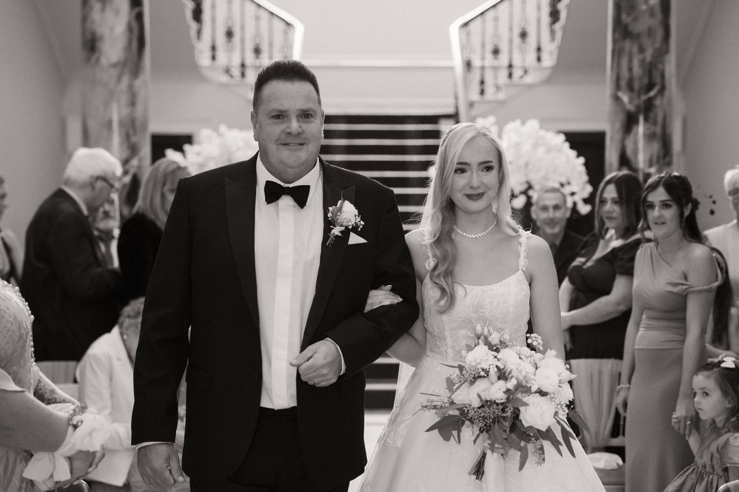 A black and white collage of wedding moments showing guests celebrating and a couple during their special day.