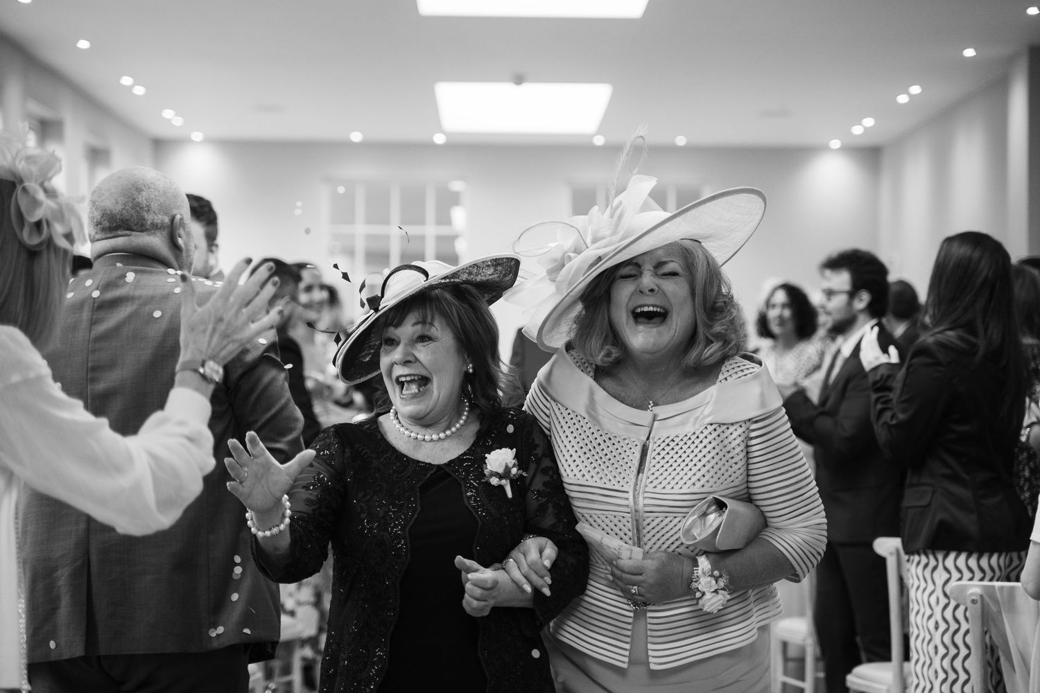 Group of people celebrating enthusiastically in a bright indoor space.