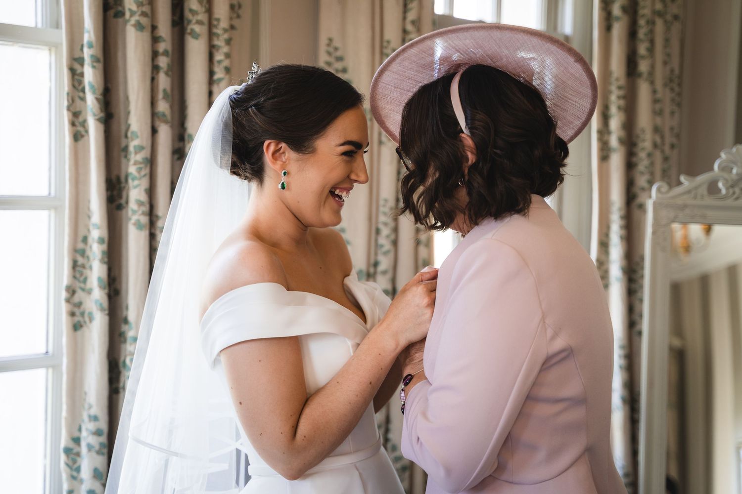A series of candid moments showing a couple embracing and sharing intimate whispers during a wedding celebration.