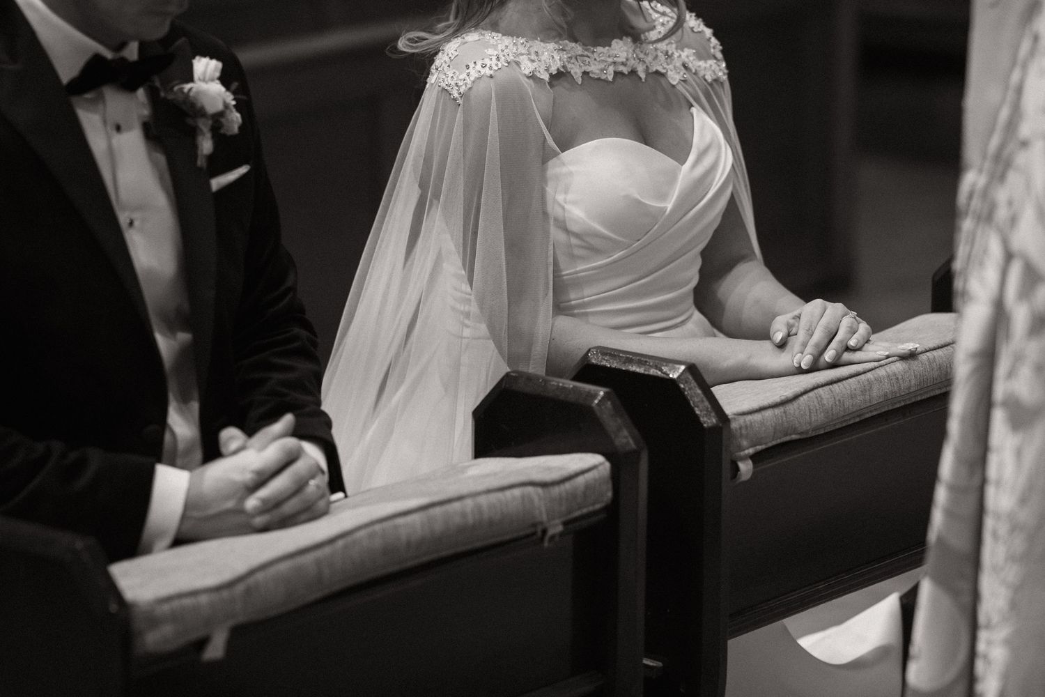 Artistic black and white detail shots of a bride's dress and hands during wedding ceremony.