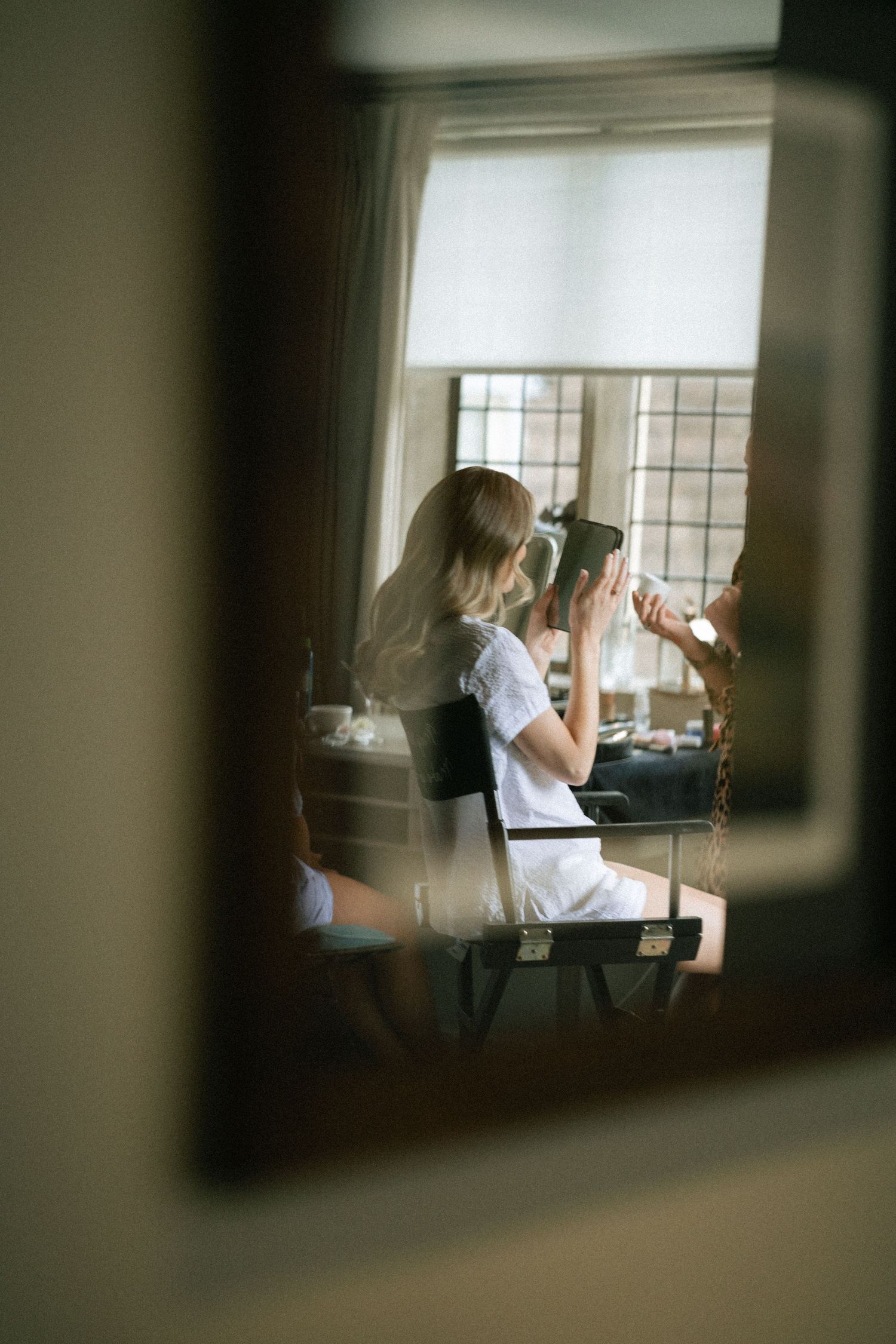 A sequence of moody window views showing someone in an office working at a desk with dramatic lighting.
