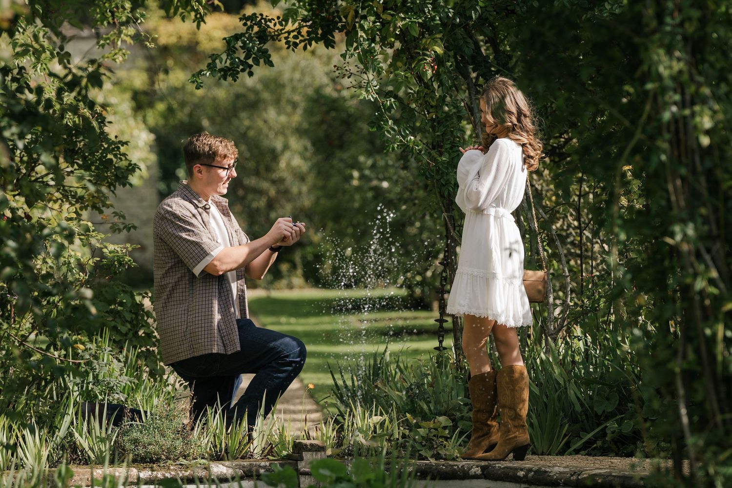 A couple in a garden setting share tender moments across multiple candid shots in natural sunlight.