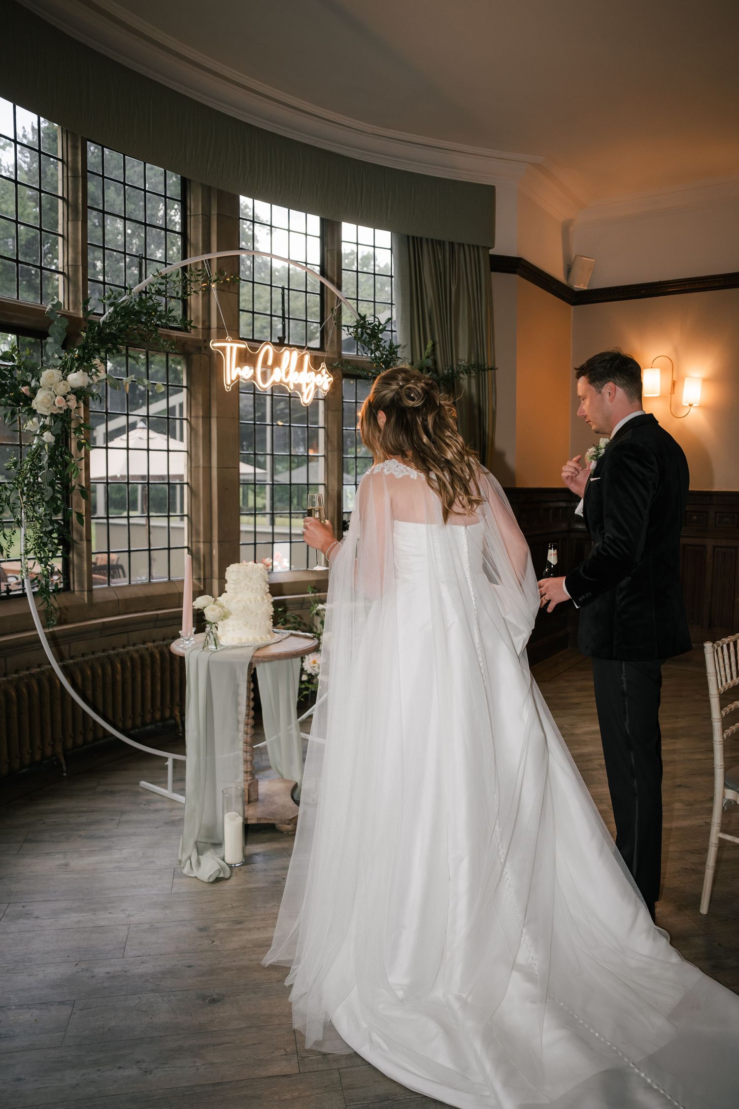 A wedding first look moment captured in a series of five sequential photos in an elegant indoor venue with large windows.