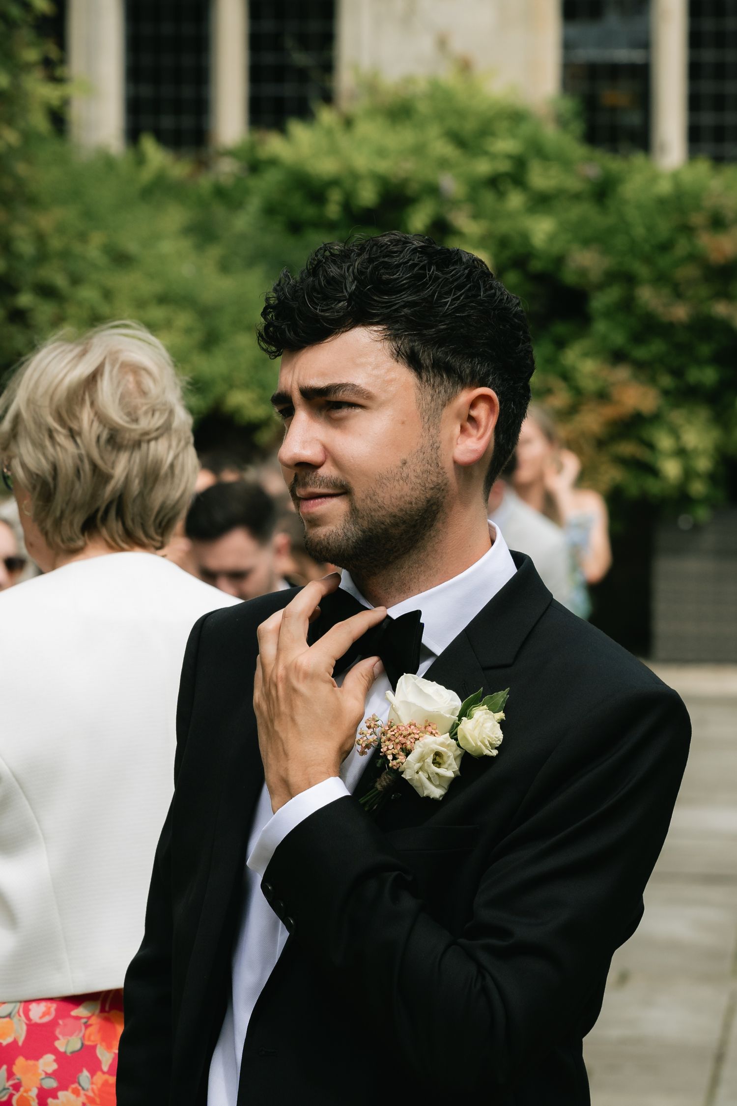 A sequence of emotional moments at a wedding showing a person in a black suit wiping away tears.