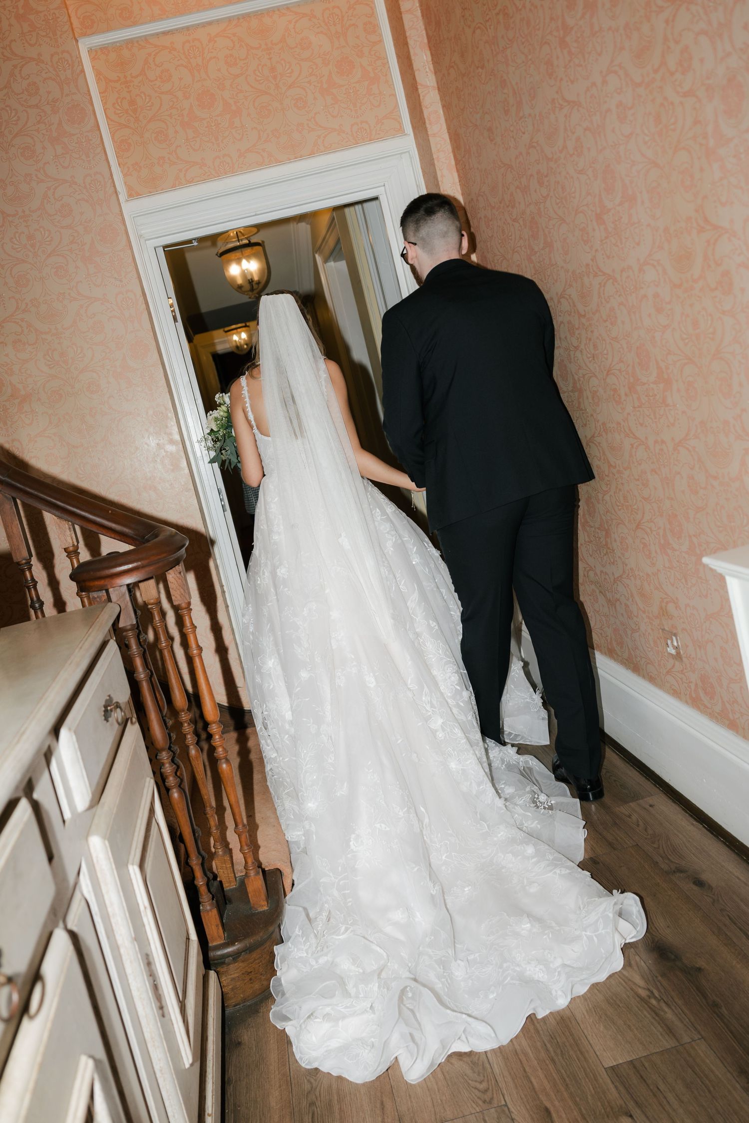 A couple in wedding attire walks up a wooden staircase in a sequence of candid shots.
