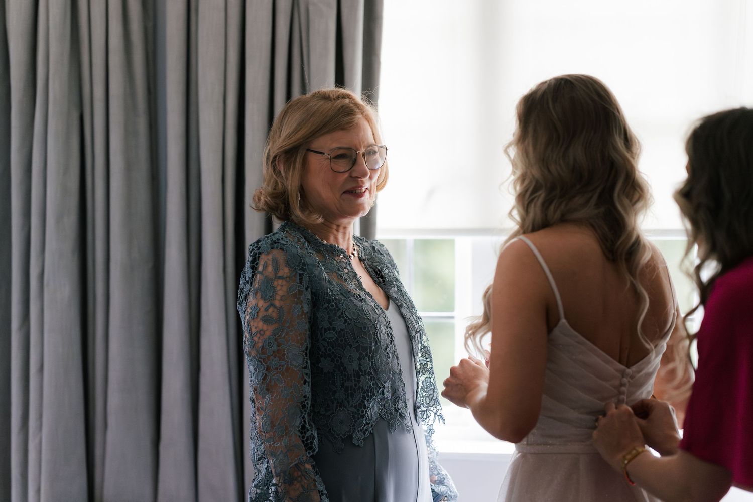 A series of candid photos showing people gathered by windows in what appears to be a wedding preparation setting.