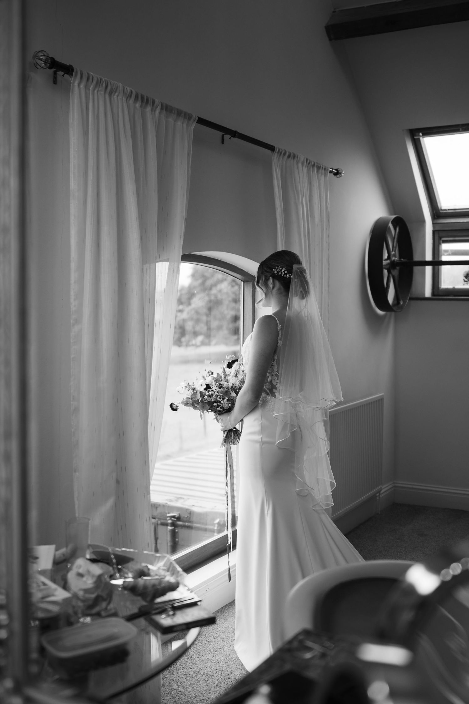 A series of black and white photos showing interior views of a room with curtains and window light.