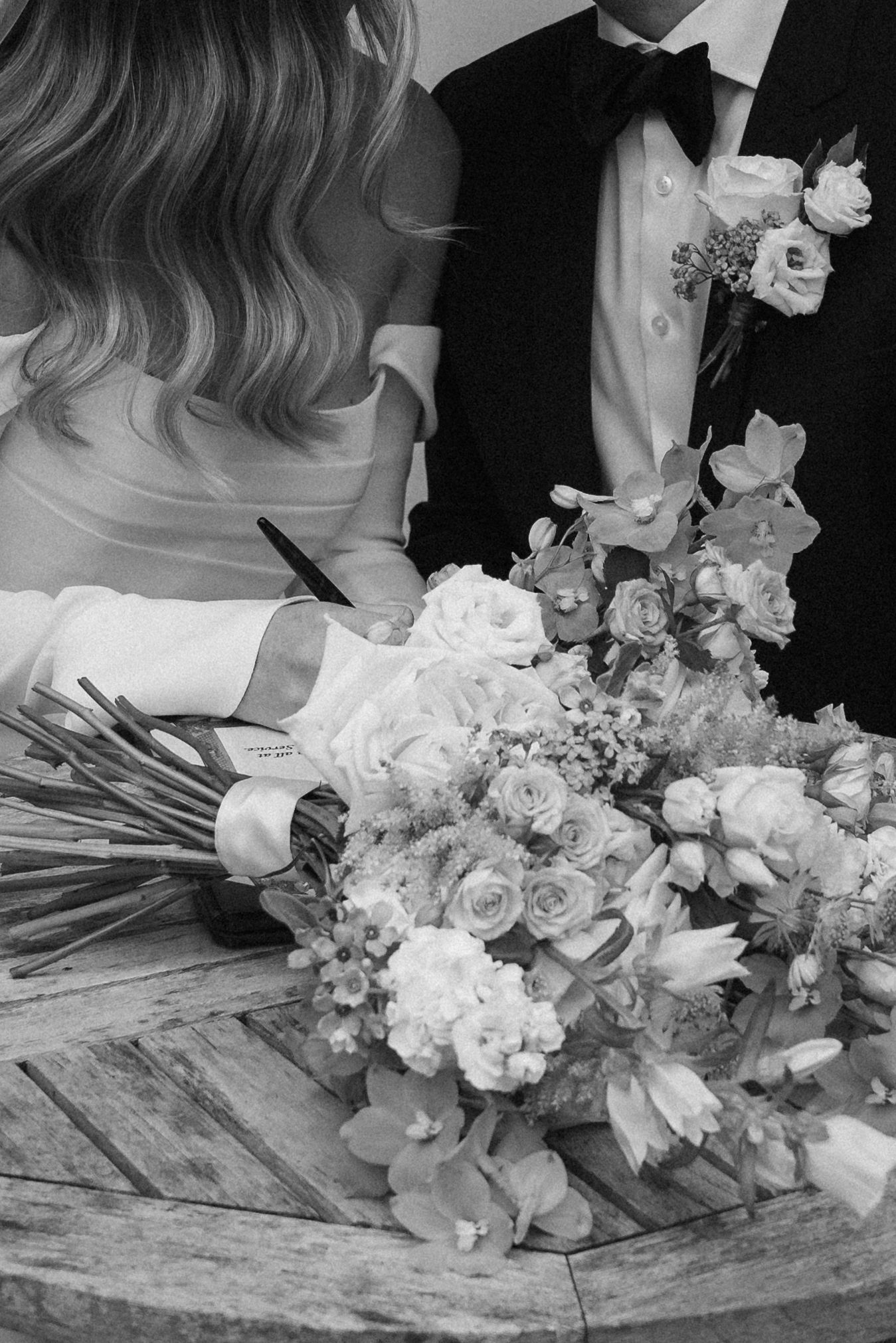 A sequence of black and white photos showing elegant wedding bouquets with roses and mixed flowers on a rustic surface.