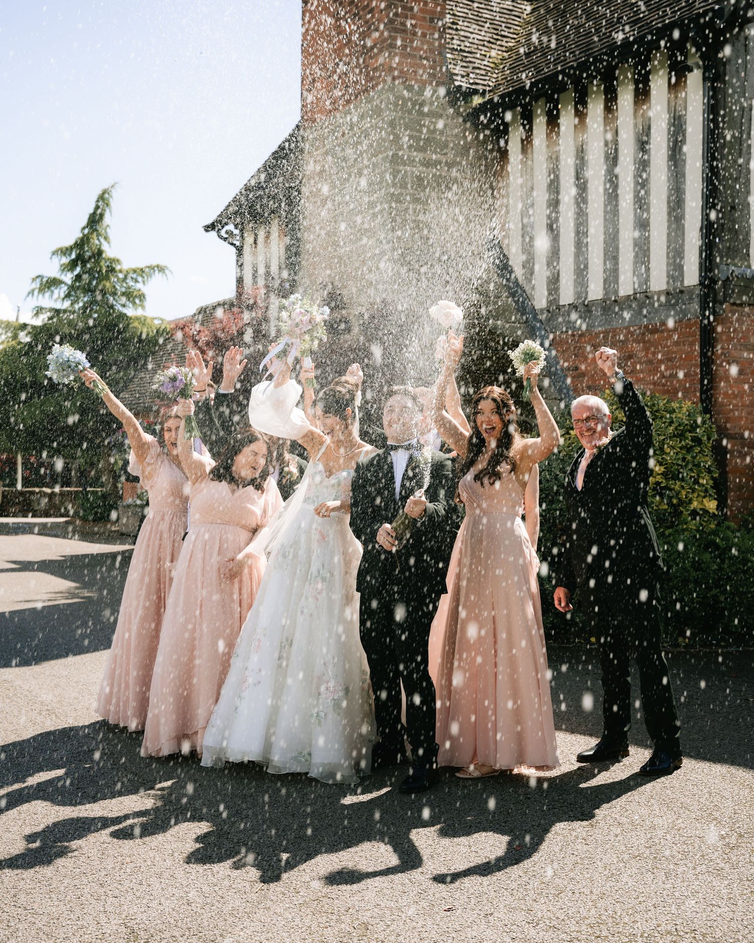Wedding party celebrates with confetti throws in sequence of joyful moments outside a brick building.