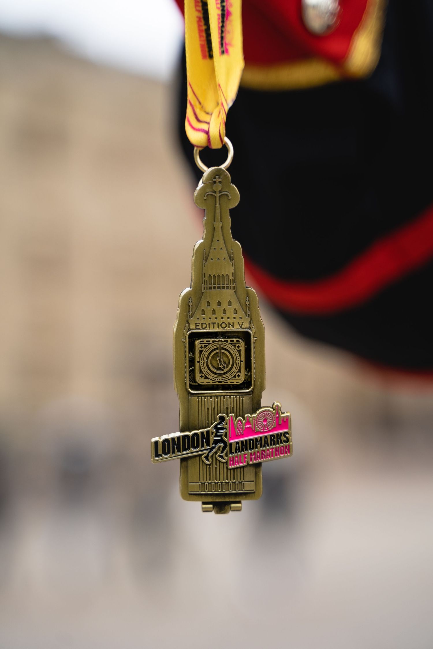A series of close-up shots showing a gold and bronze medal with a ribbon from different angles.