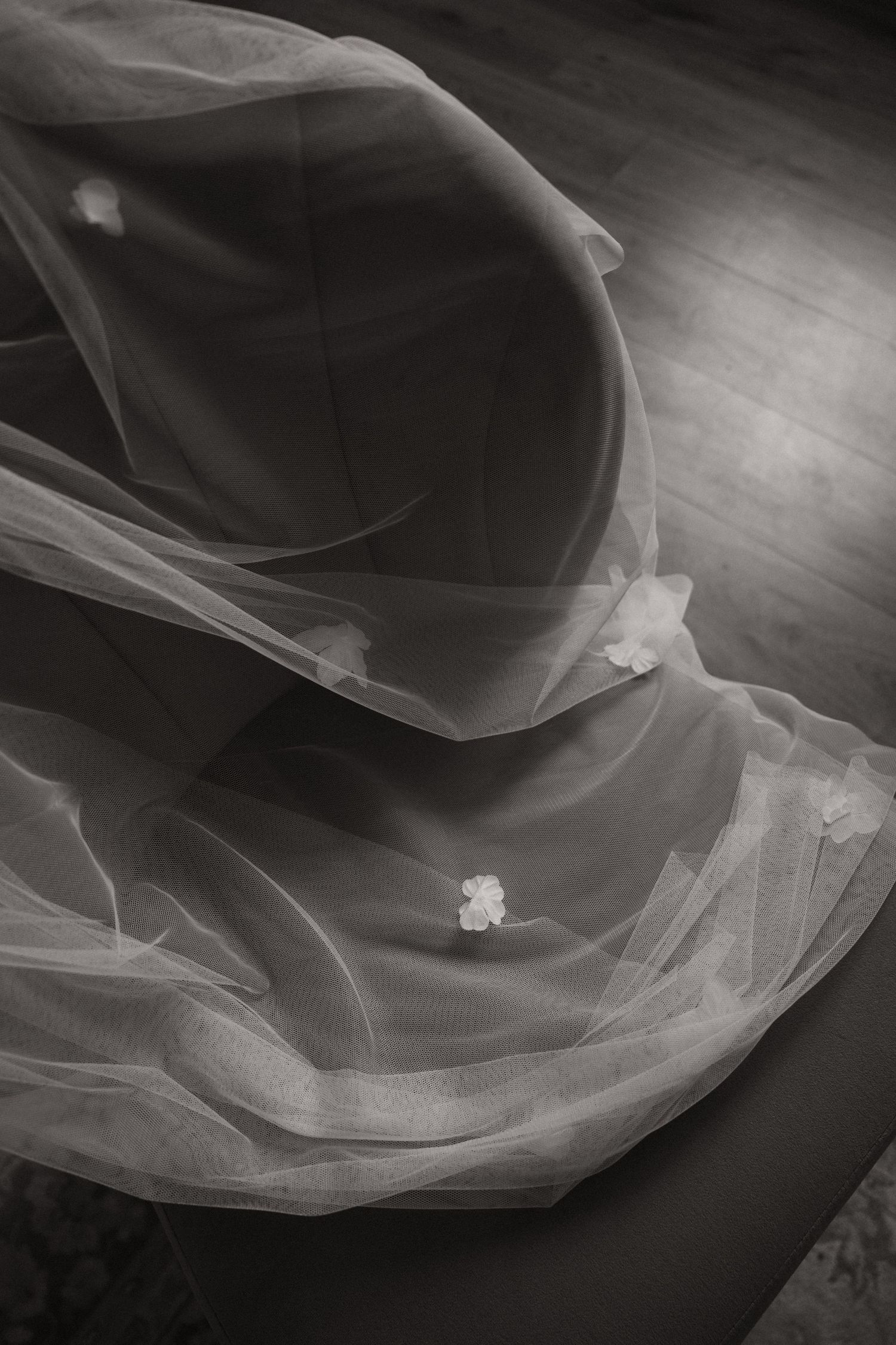 Abstract black and white photograph series showing delicate flowing fabric with ethereal light and shadow patterns.