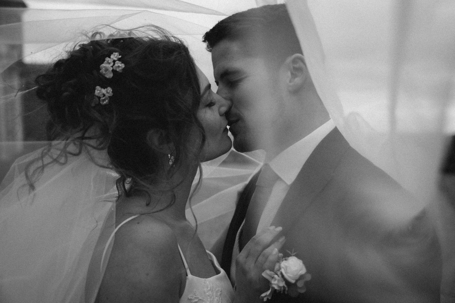 A romantic black and white wedding photo collage showing intimate moments between newlyweds during their special day.