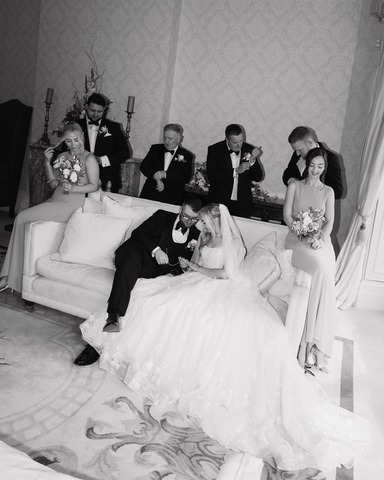 A series of wedding photos showing a couple relaxing on an elegant white sofa in formal attire.