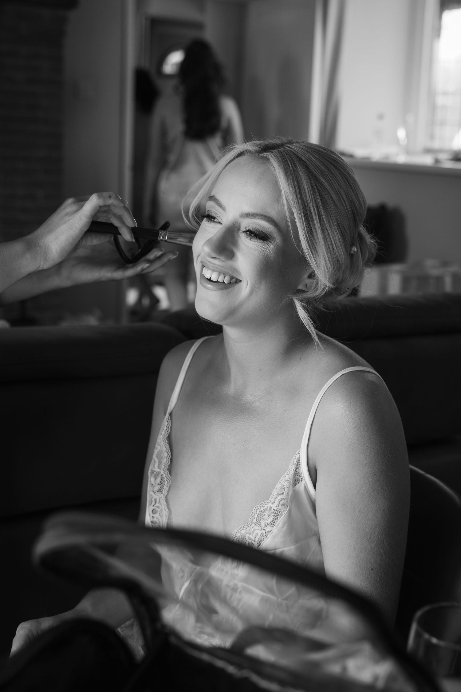A black and white photo sequence shows a bride laughing while getting ready on her wedding day.