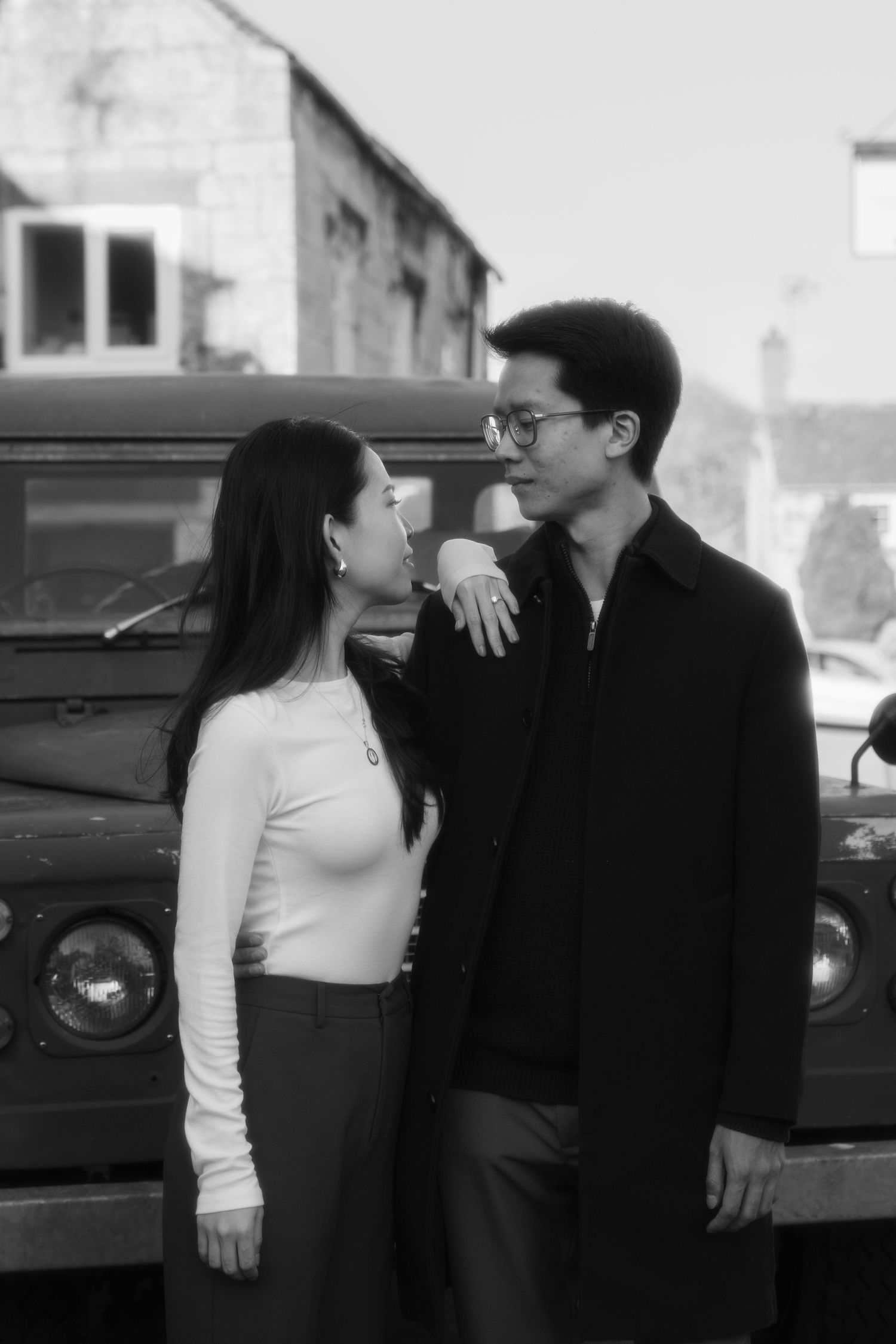 Vintage style photo of couple in contrasting black and white outfits sharing intimate moment.