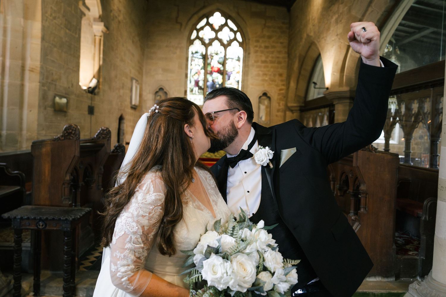 Bride and groom share romantic kisses in a sequence of four photos inside an elegant church setting.