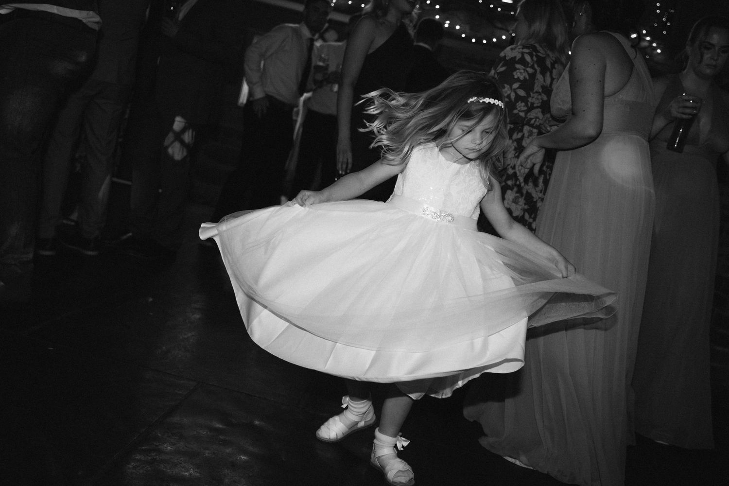 A collection of wedding photos showing elegant white dresses and romantic moments on a dance floor.