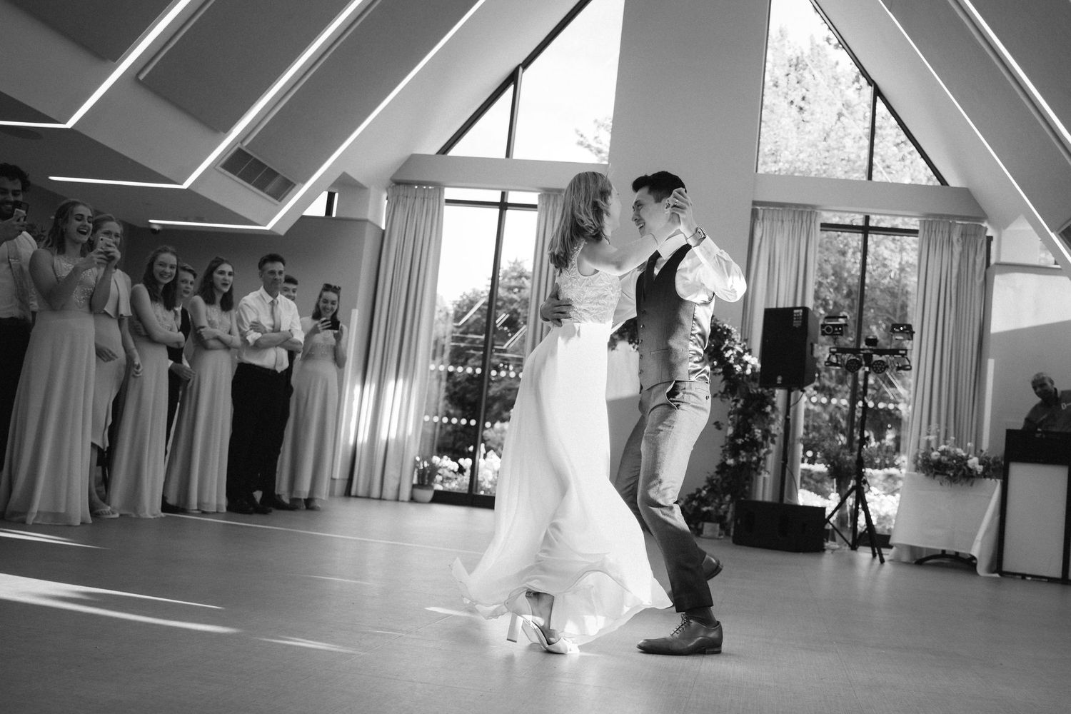 A sequence of wedding dance photos showing a couple performing a choreographed dance routine in a bright indoor venue.