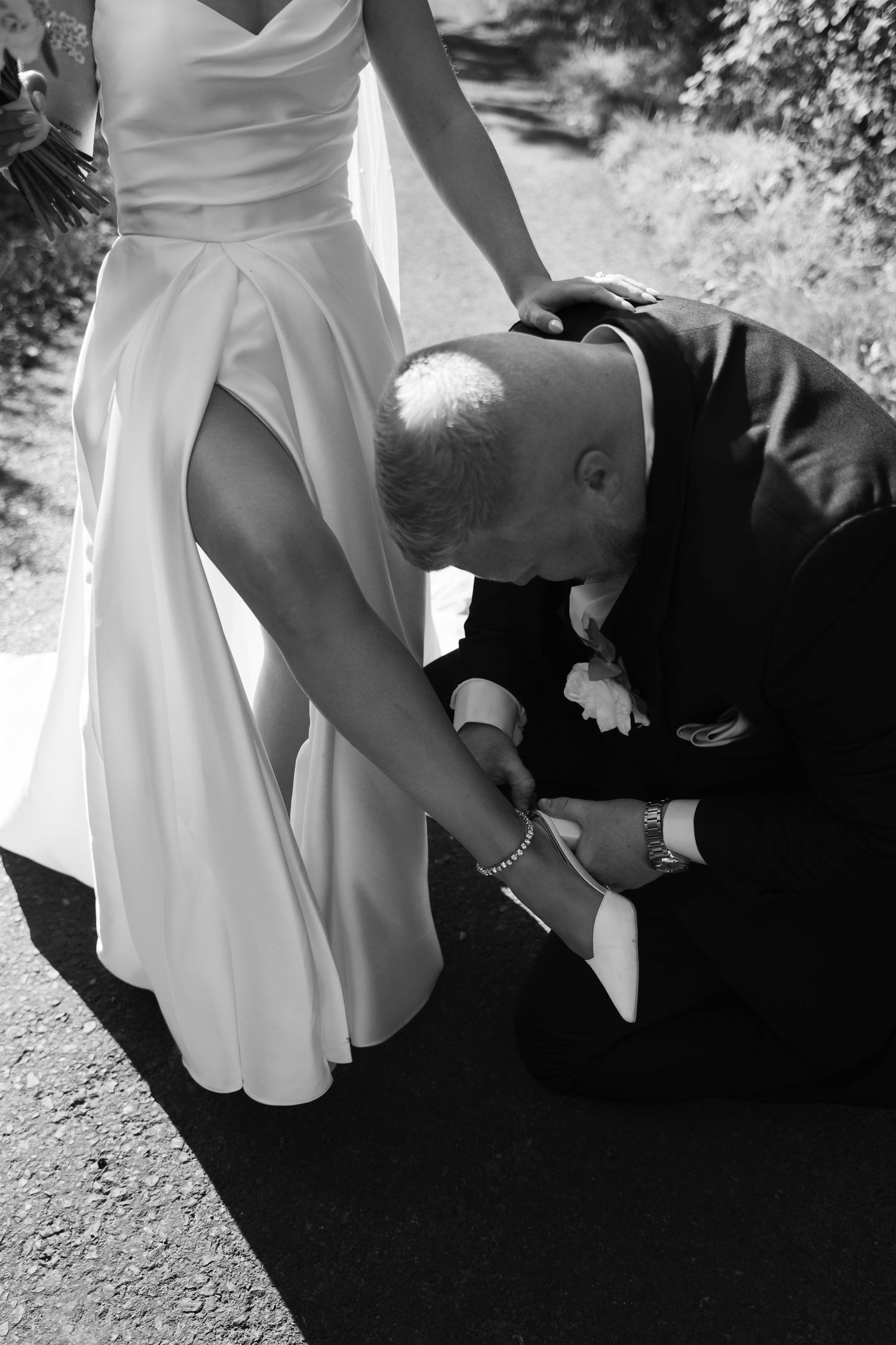 A sequence of black and white photos showing a person in formal attire kneeling down beside someone in a white dress.