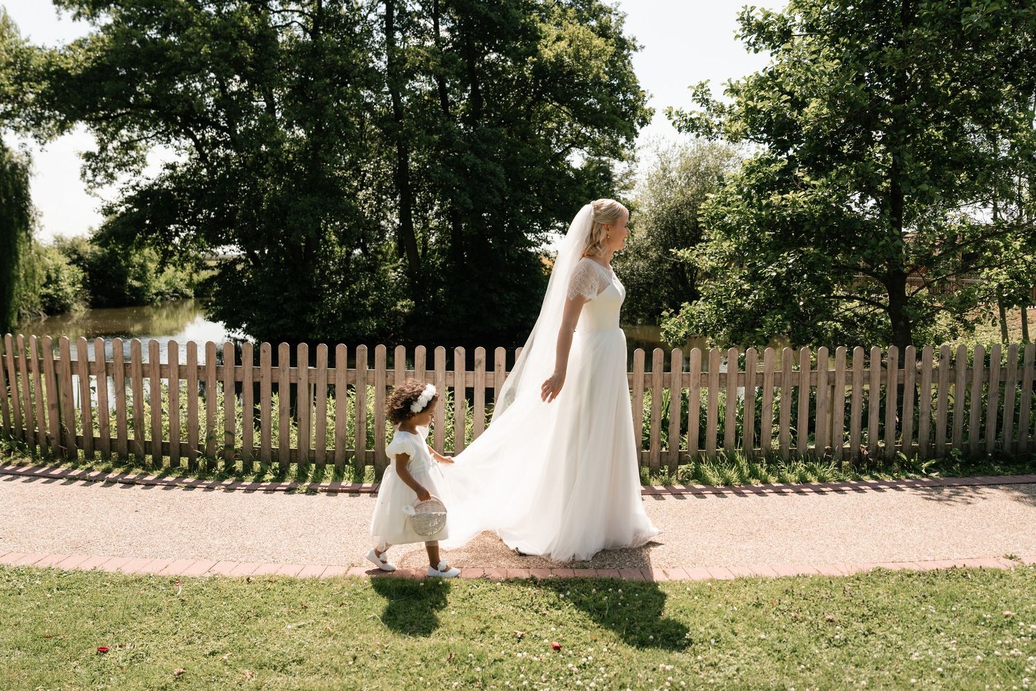 Outdoor wedding photography sequence with white picket fence and garden backdrop.